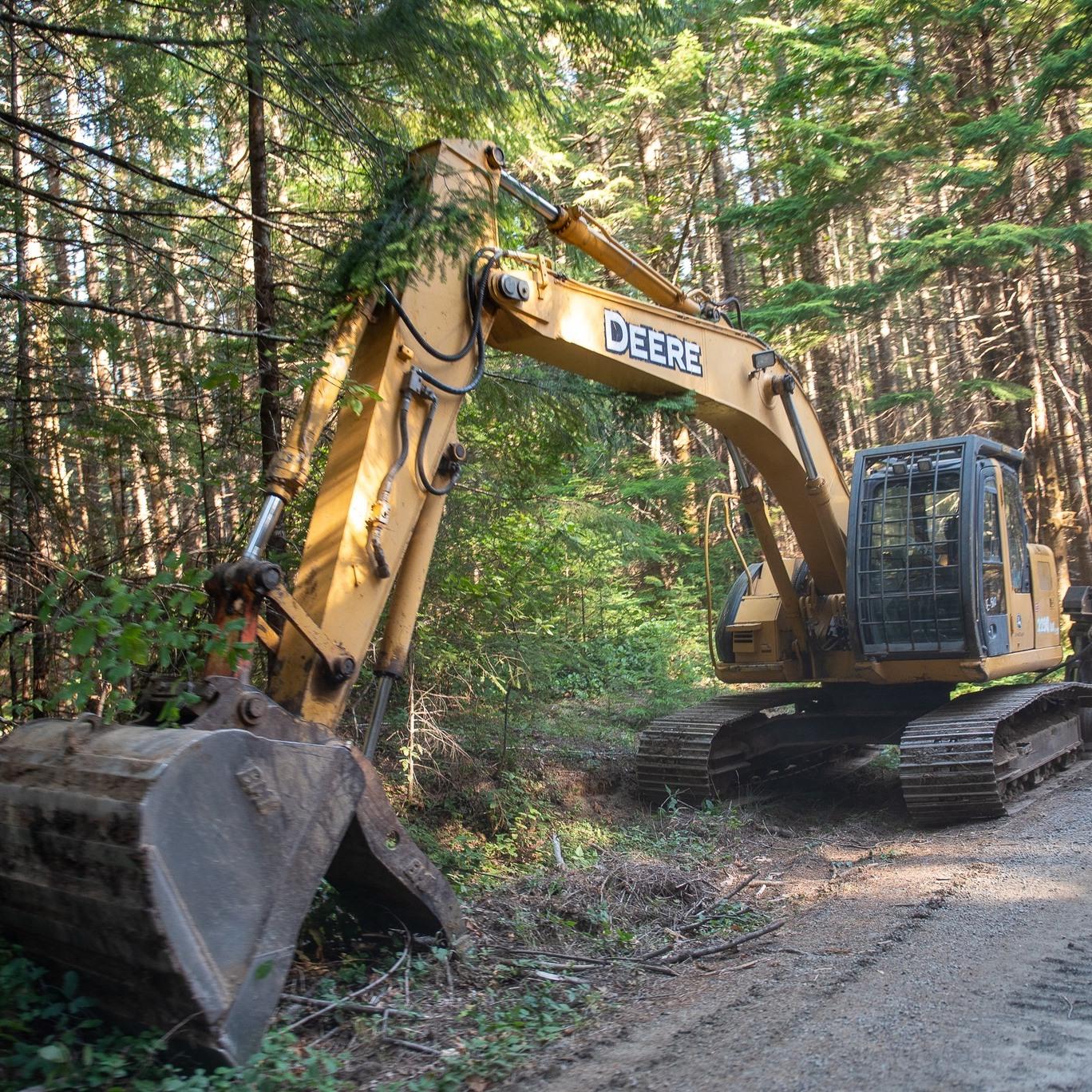 This is an image of an excavator working near the road