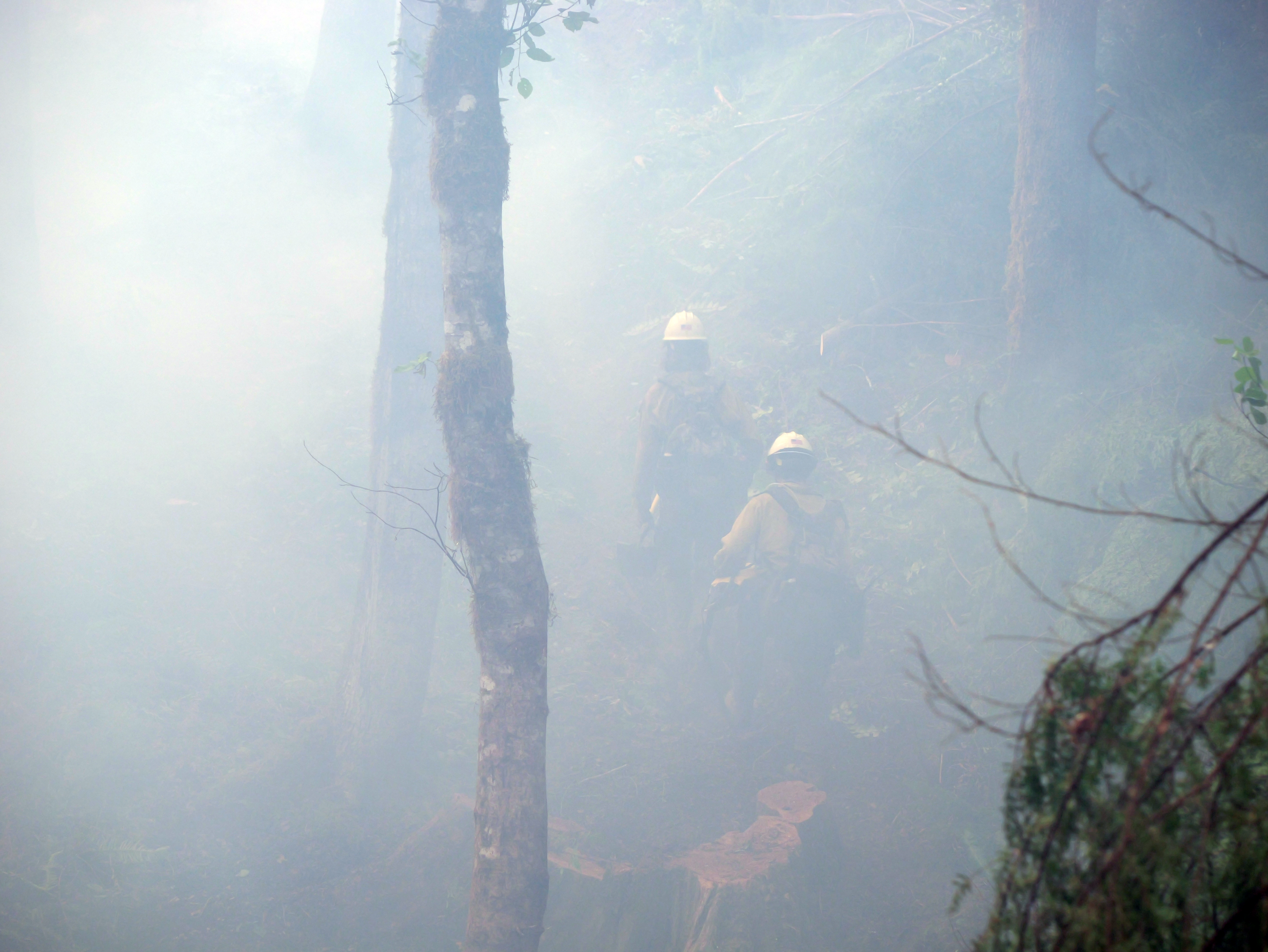 Heavy smoke surrounds two firefighters on the Horse Creek Fire.