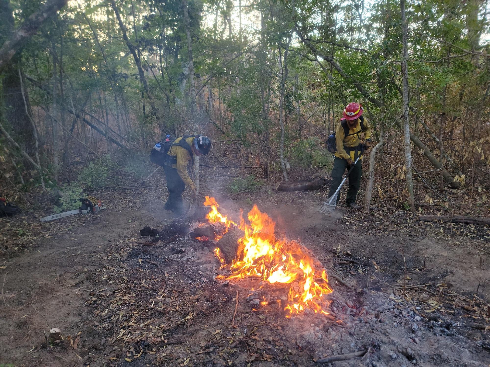 Firefighters isolate an interior heat on the Elizabeth Fire