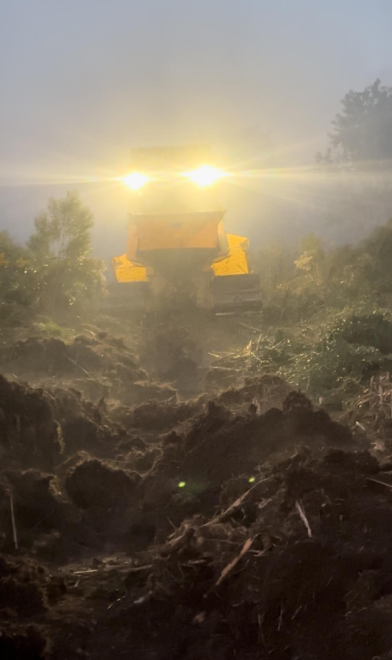 This is an image of a bulldozer in the dark