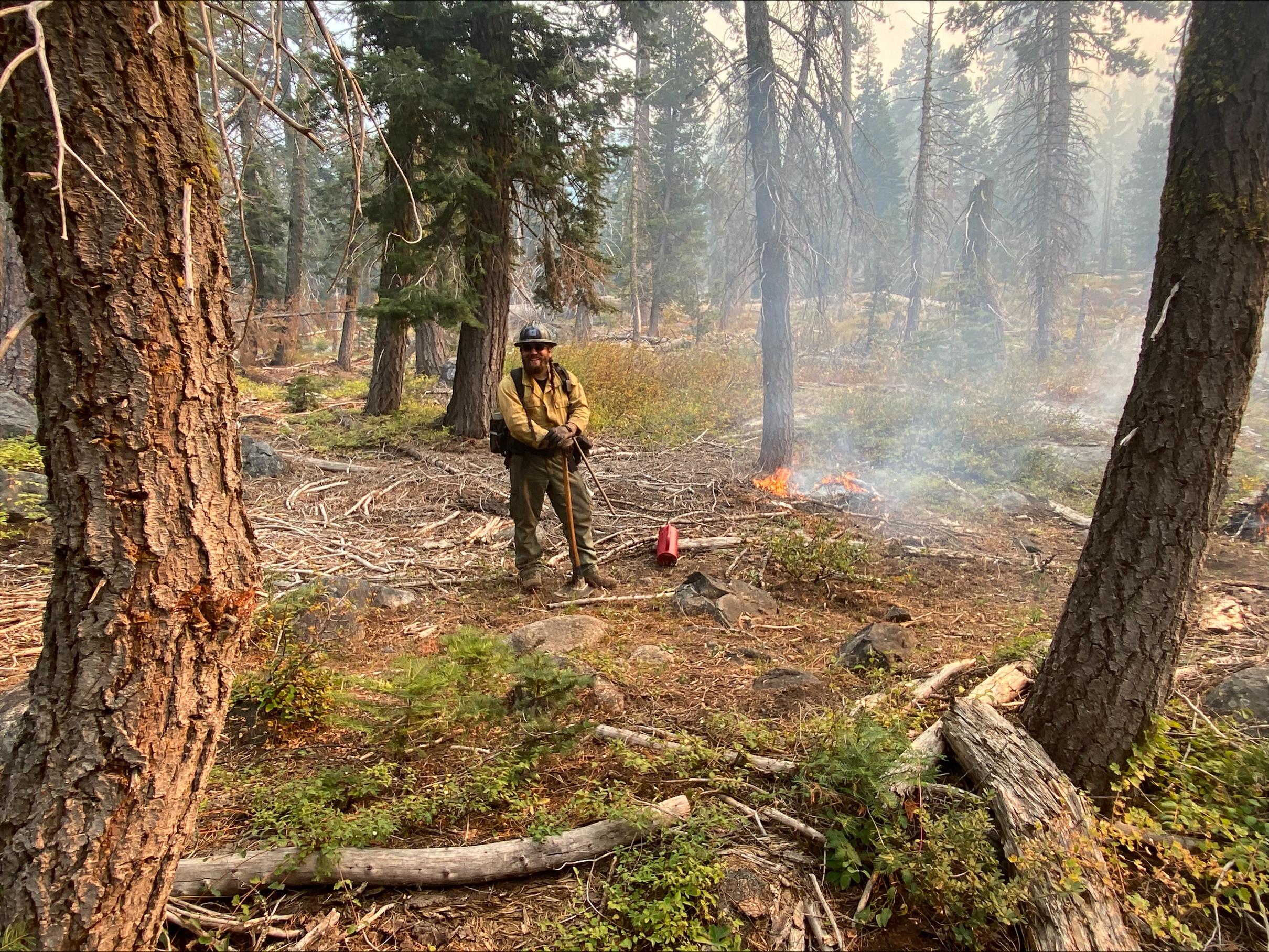 Crew member burning low intensity fire. 