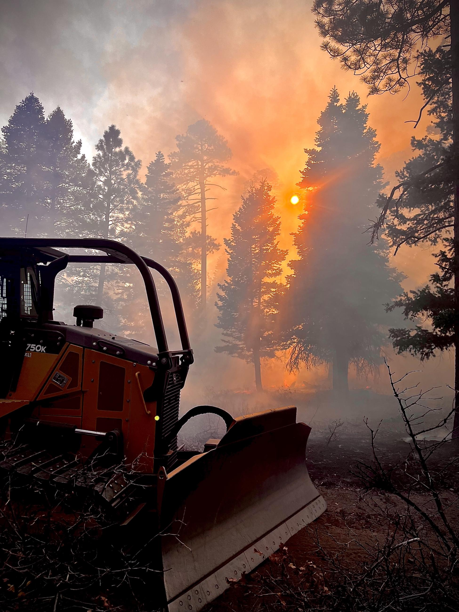 The sun goes down through smoke from the Trail Springs Fire on October 25, 2023.