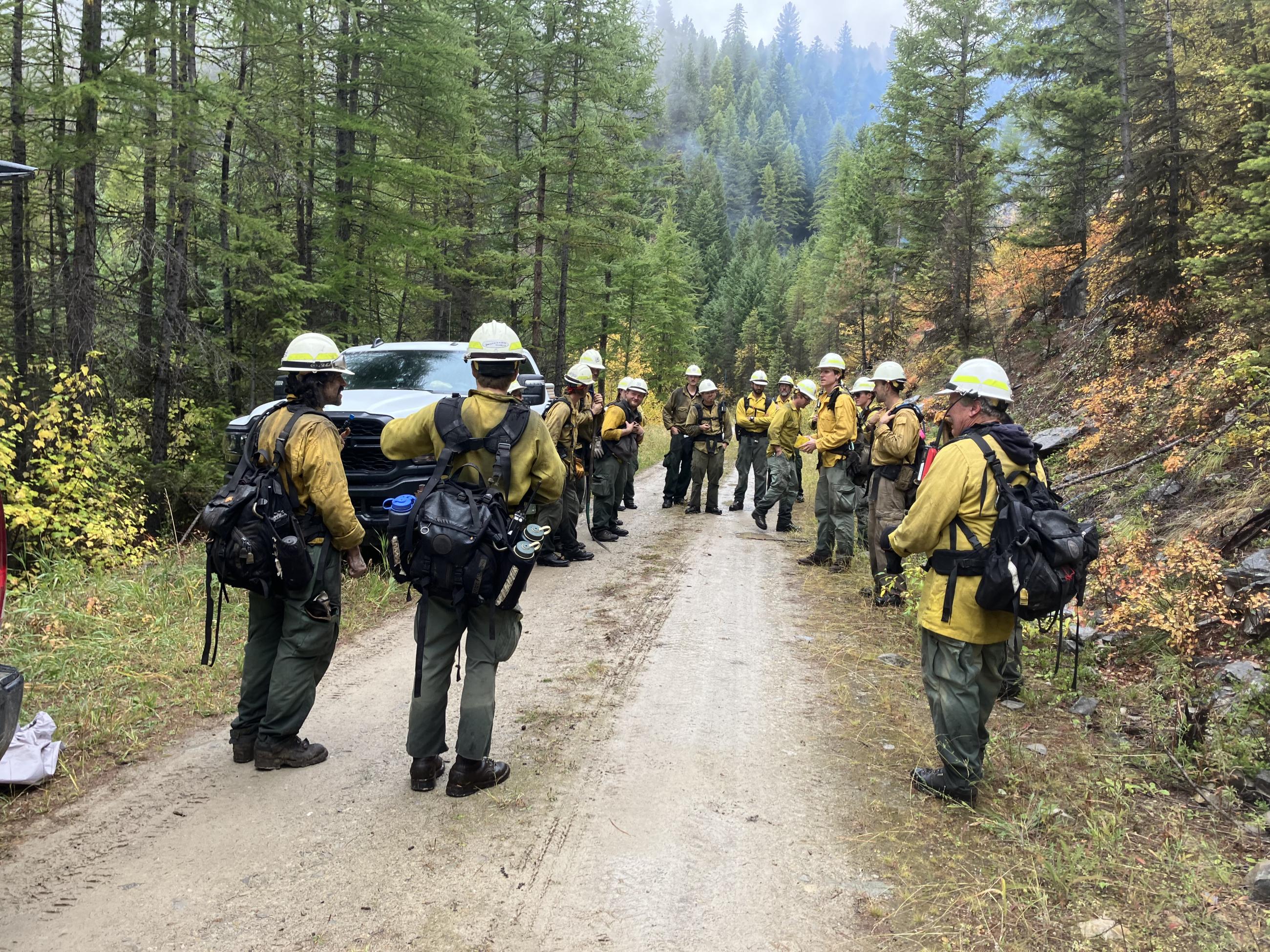 Firefighters in nomex standing around preparing for a prescribed fire 