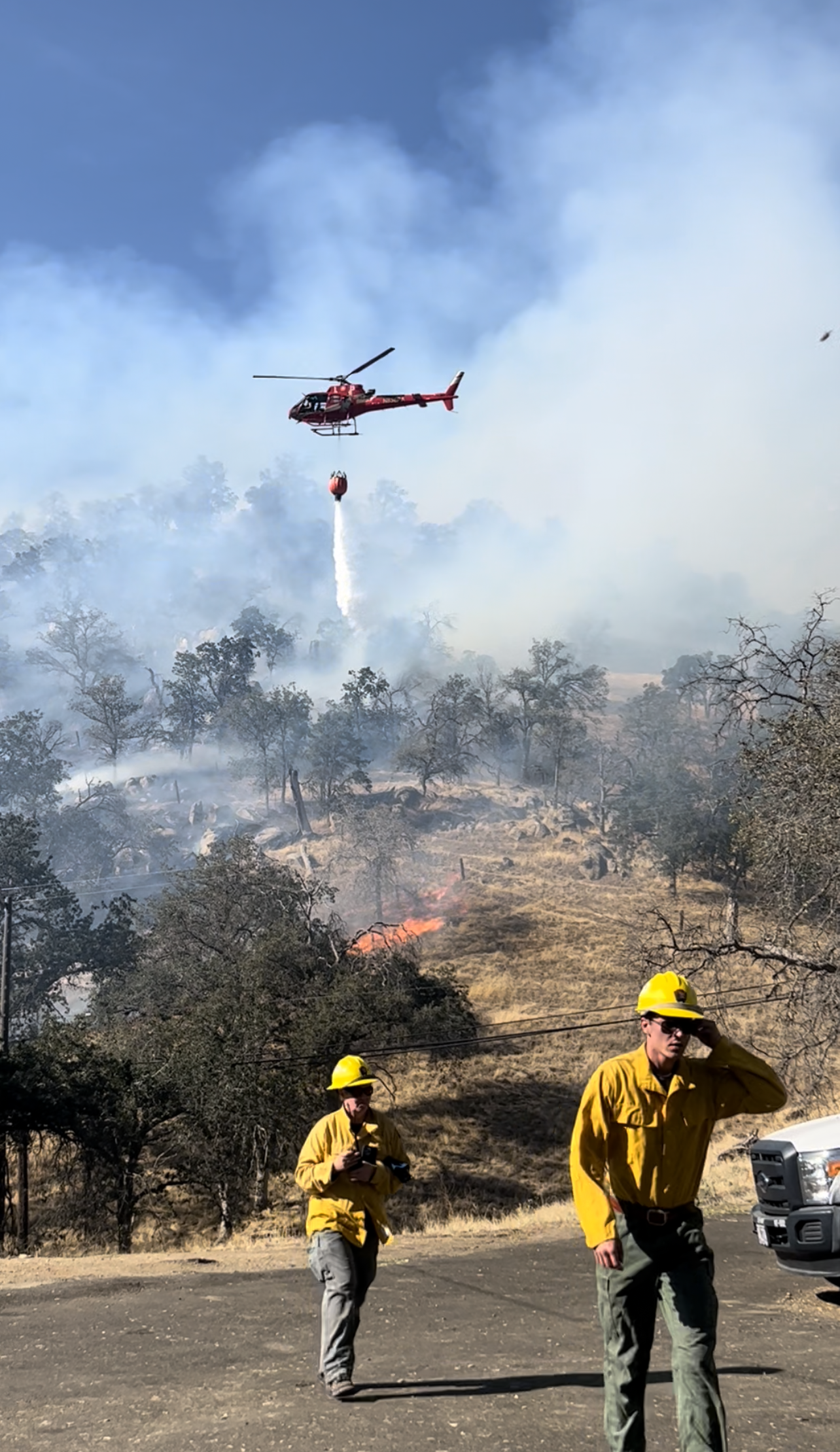 Firefighters and helicopter and smoke