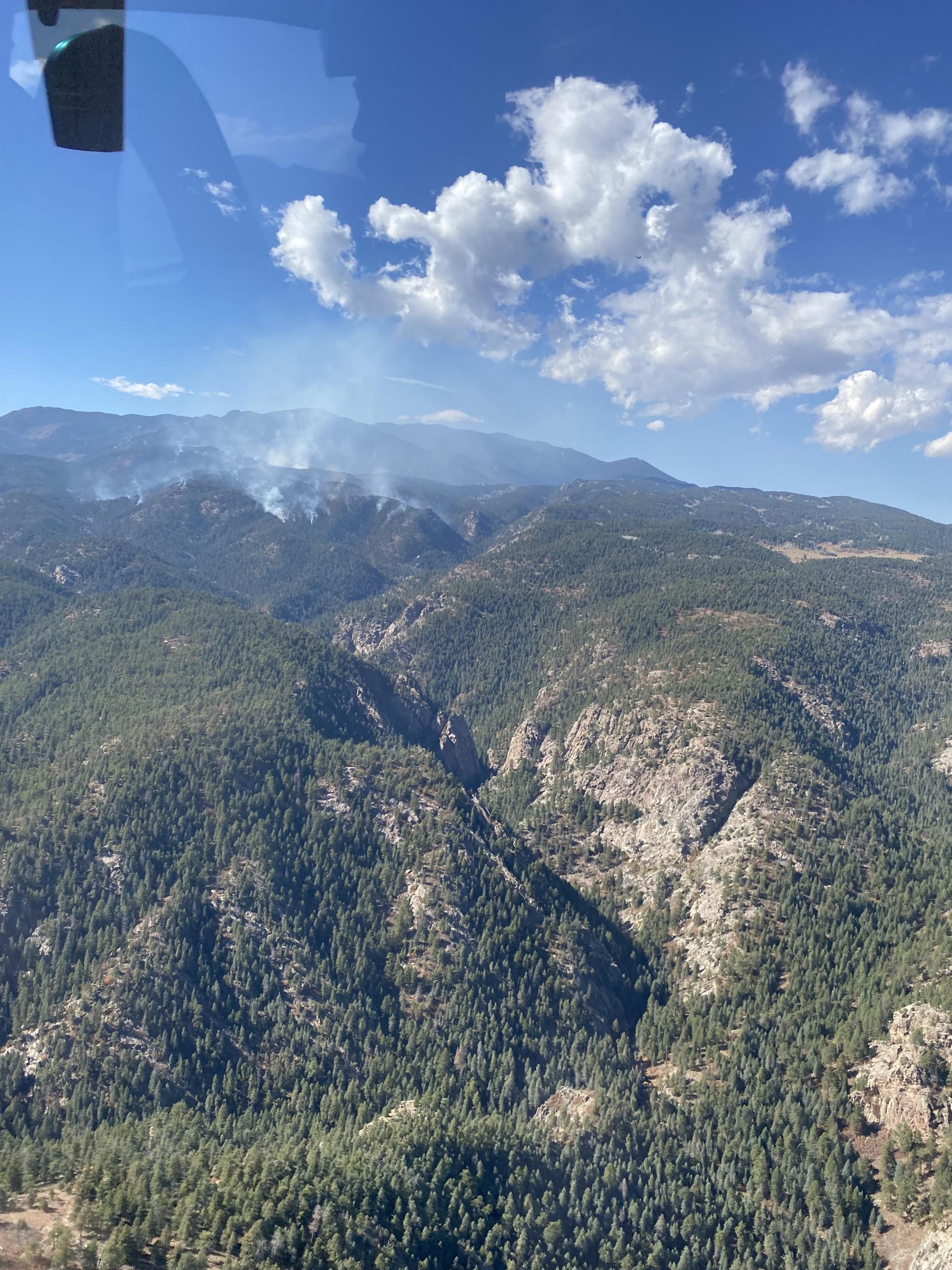 Smoke in the mountain, deep canyon. View from helicopter.
