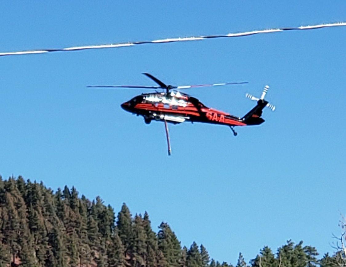 Helicopter flying over Saint Charles fire helping with fire suppression. 