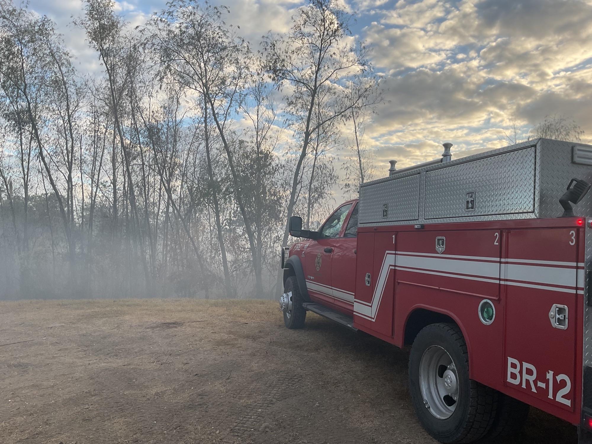 This is an image of a brush truck in the early morning fog