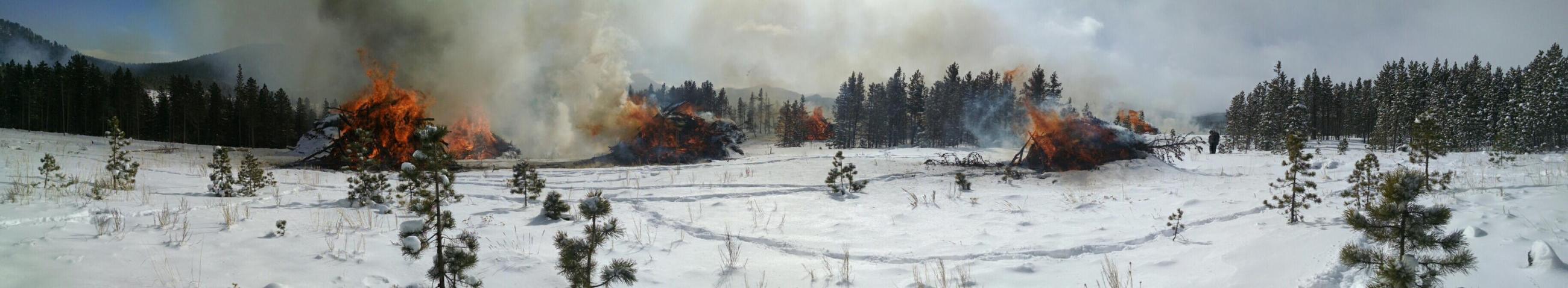 smoke and piles burning in snow