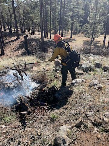 Firefighter monitoring the fuel piles on the prescribed burn.