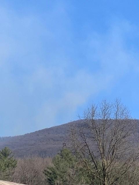 View of mountain with blue smoky sky