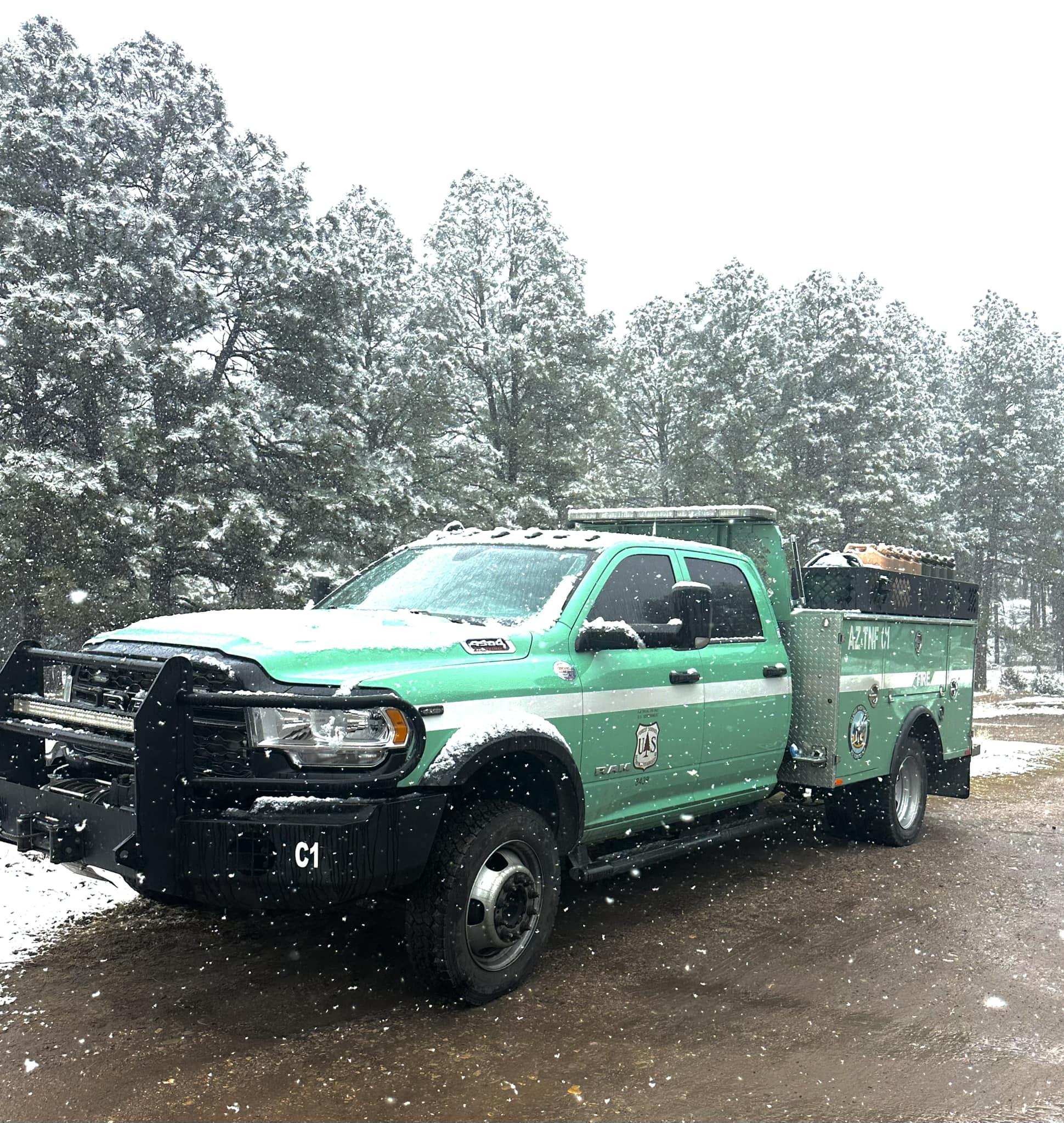 Snowfall landing around a Hotshot vehicle on the Lincoln National Forest