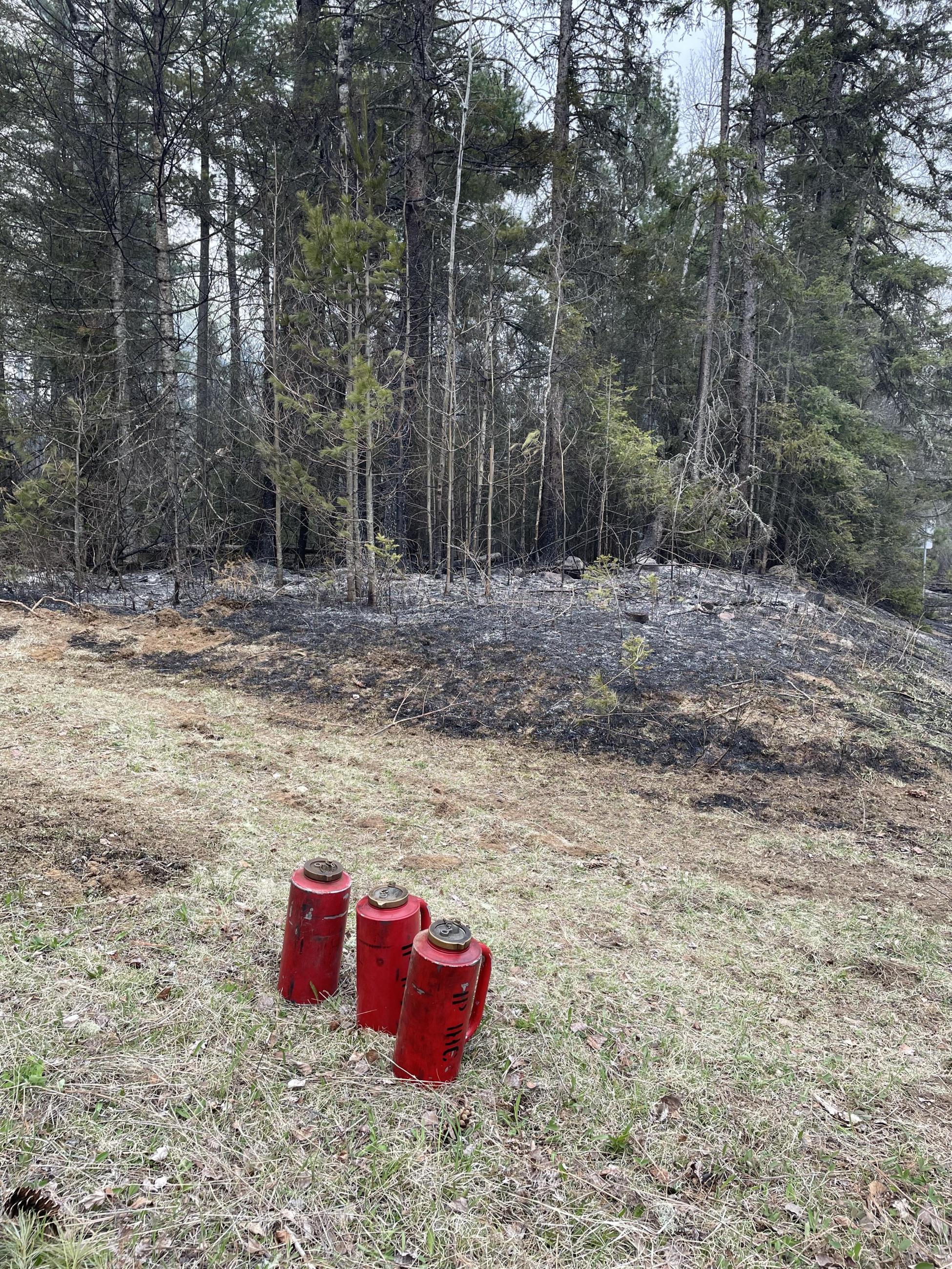 Image of 3 red drip torch cans 