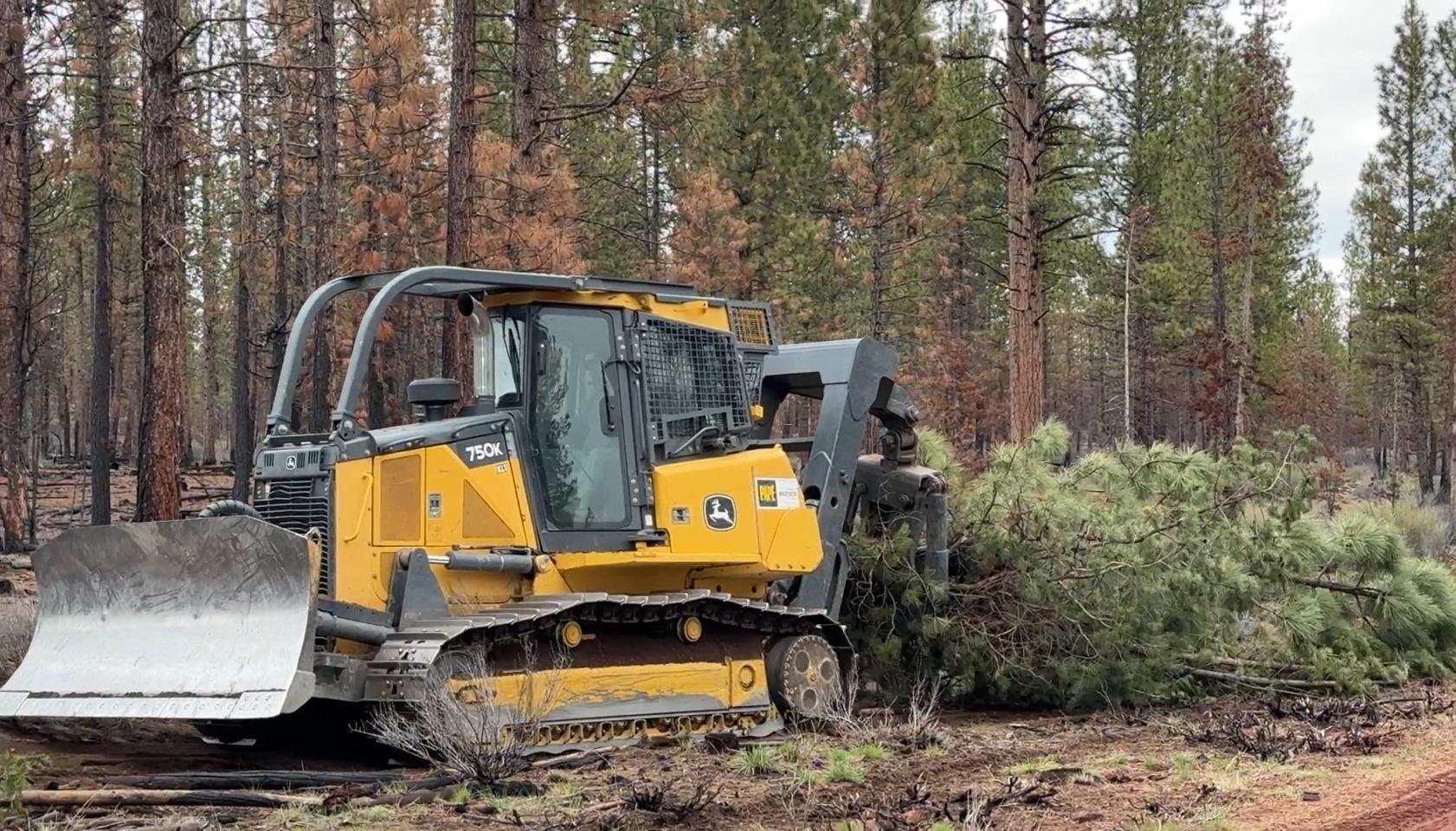 Dozer with Grapple Hook skids Debris 