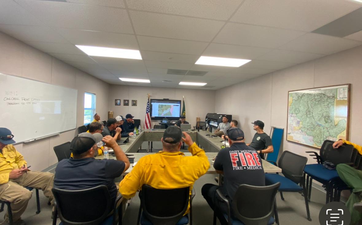 Fire management staff gather for a briefing on the Boulder Fire 