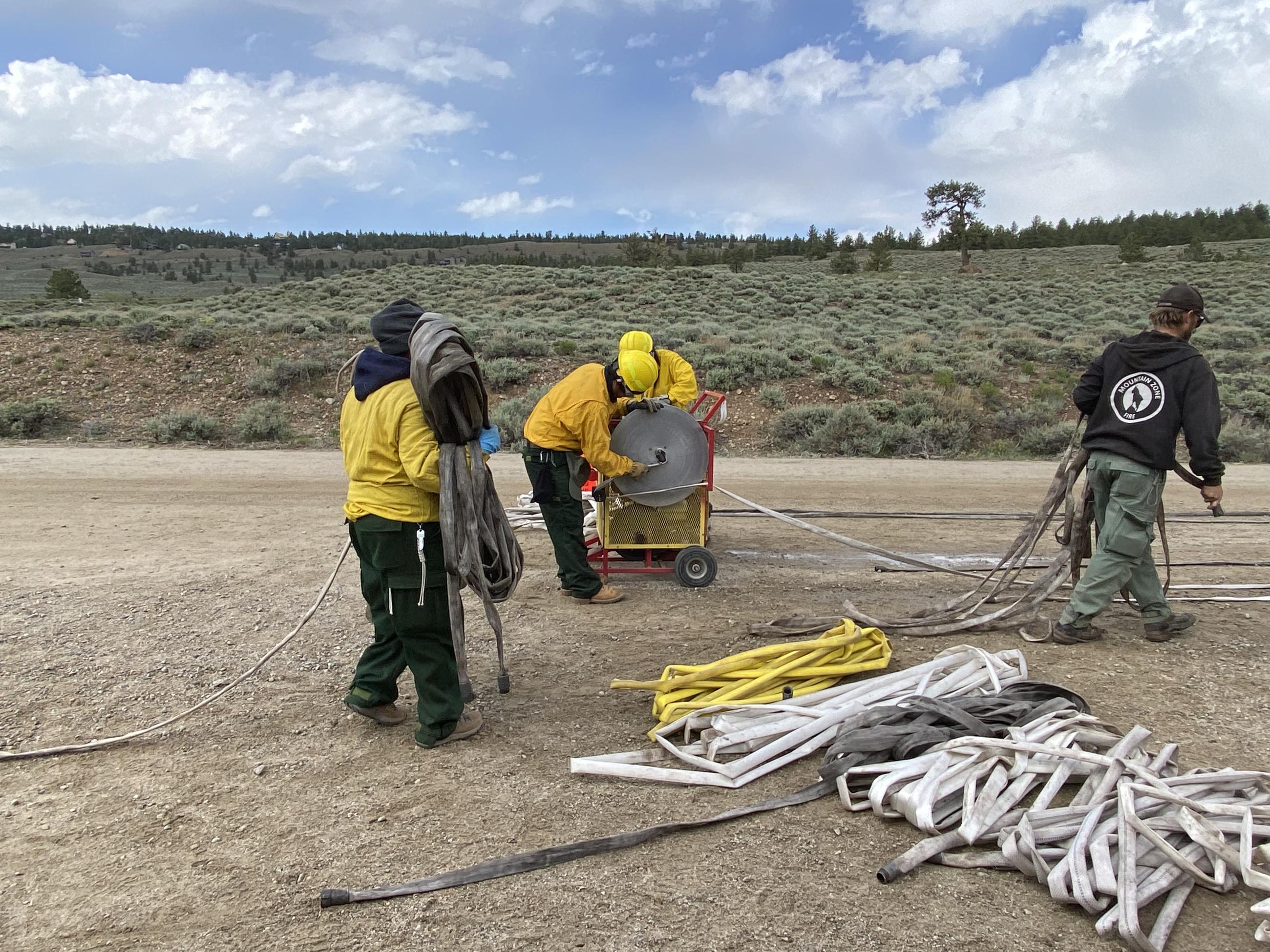 Image of camp crew rolling hose on the Interlaken fire