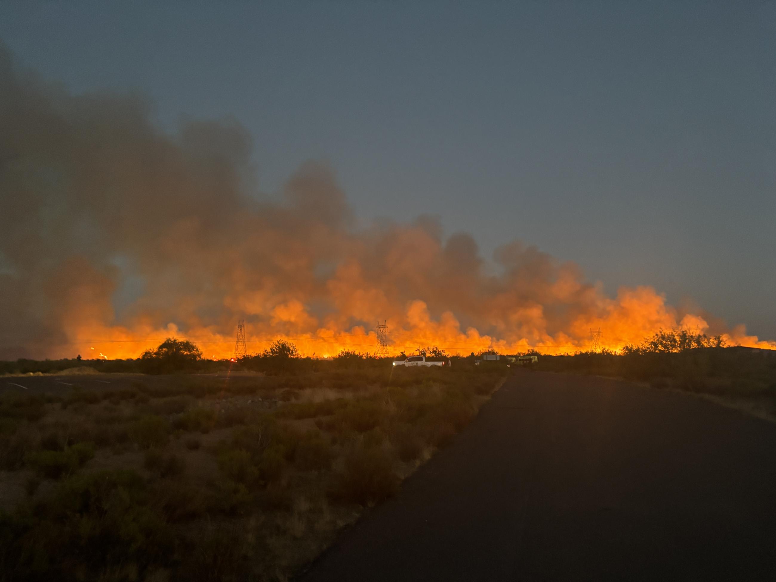 Crews work to slow fire spread by burning vegetation between Bartlett Dam Road and the main fire