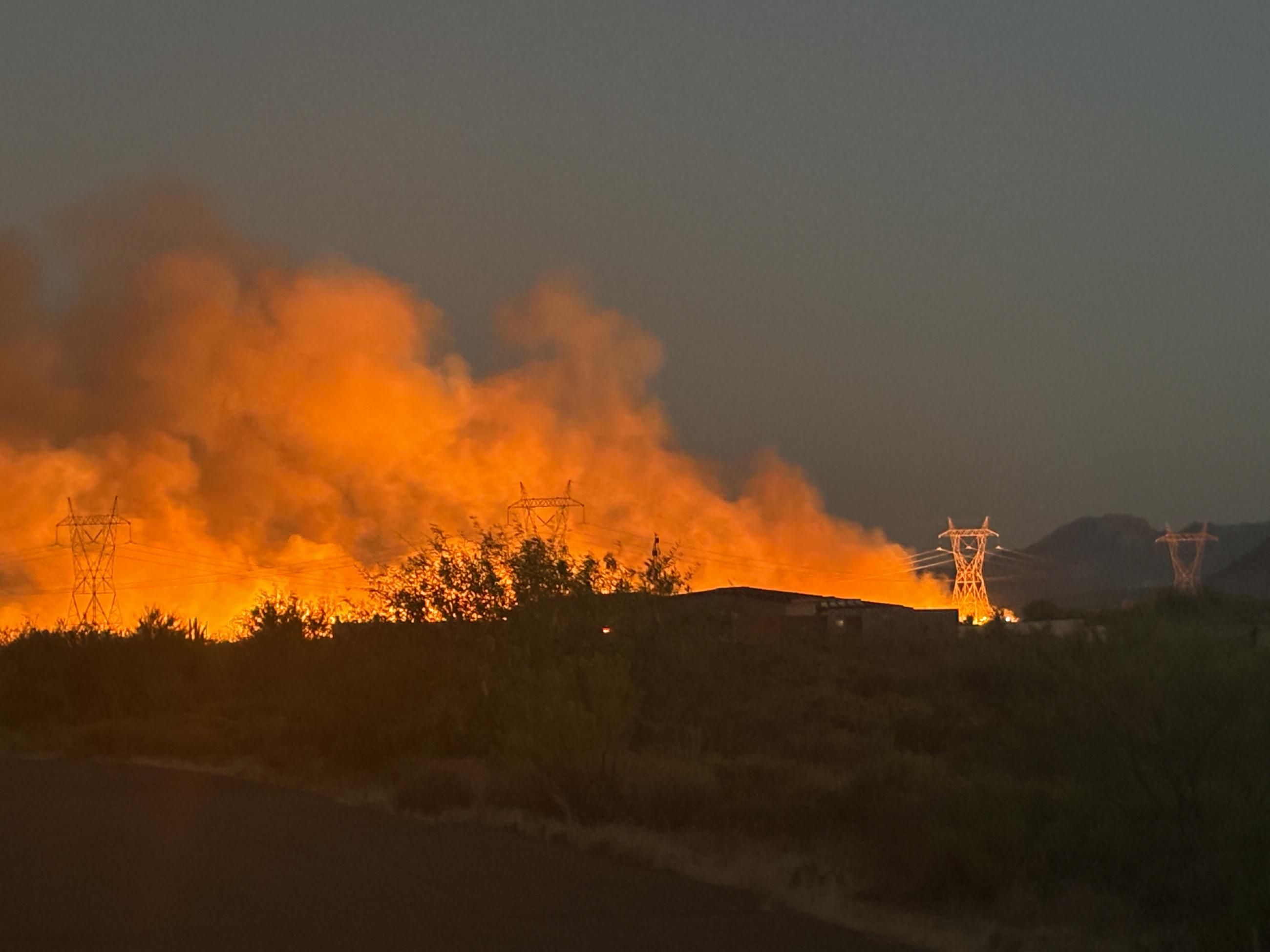 Crews work to slow fire spread by burning vegetation between Bartlett Dam Road and the main fire