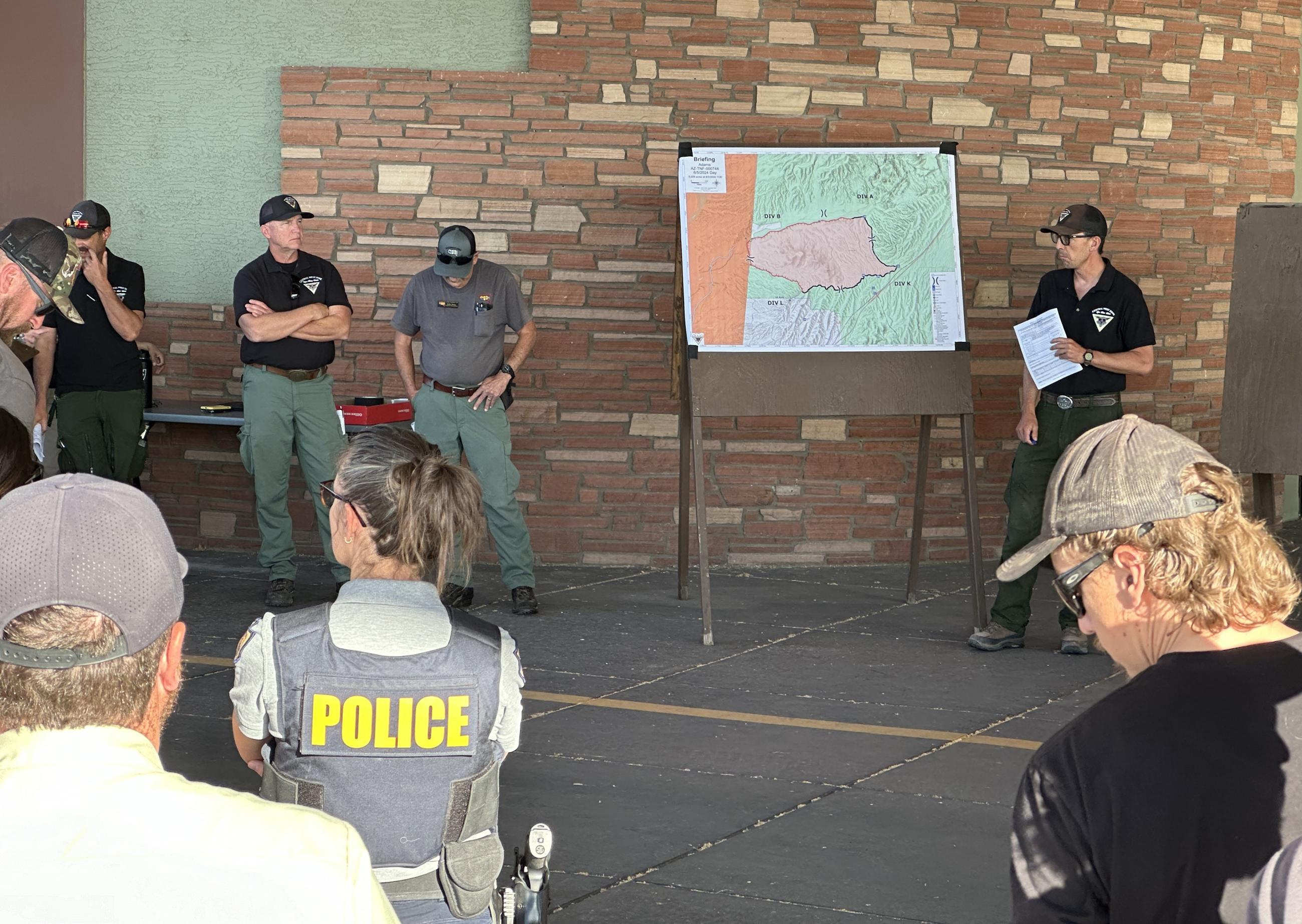 Resources assigned to the Adams Fire listen to the operational plan for the day