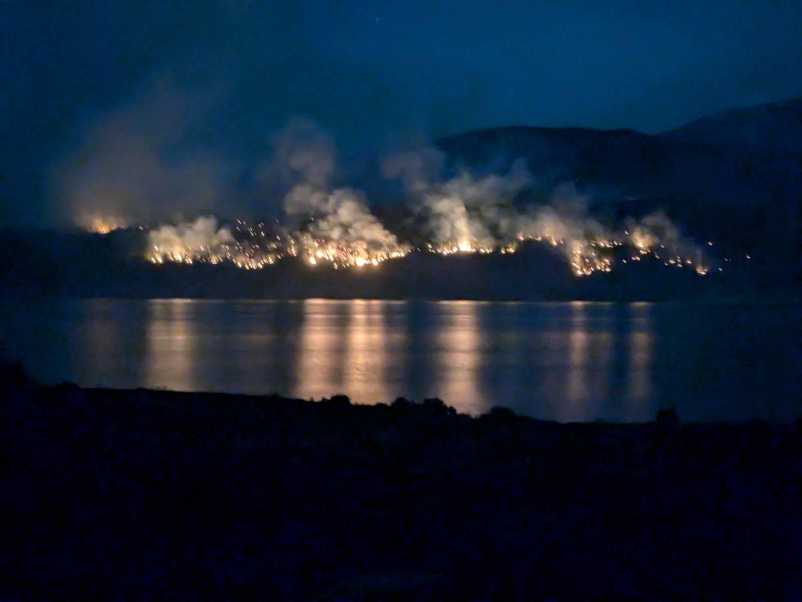 Image of the Interlaken Fire evening of June 14, 2024 with fire and smoke burning on the other side of Twin Lakes, south of Leadville, CO