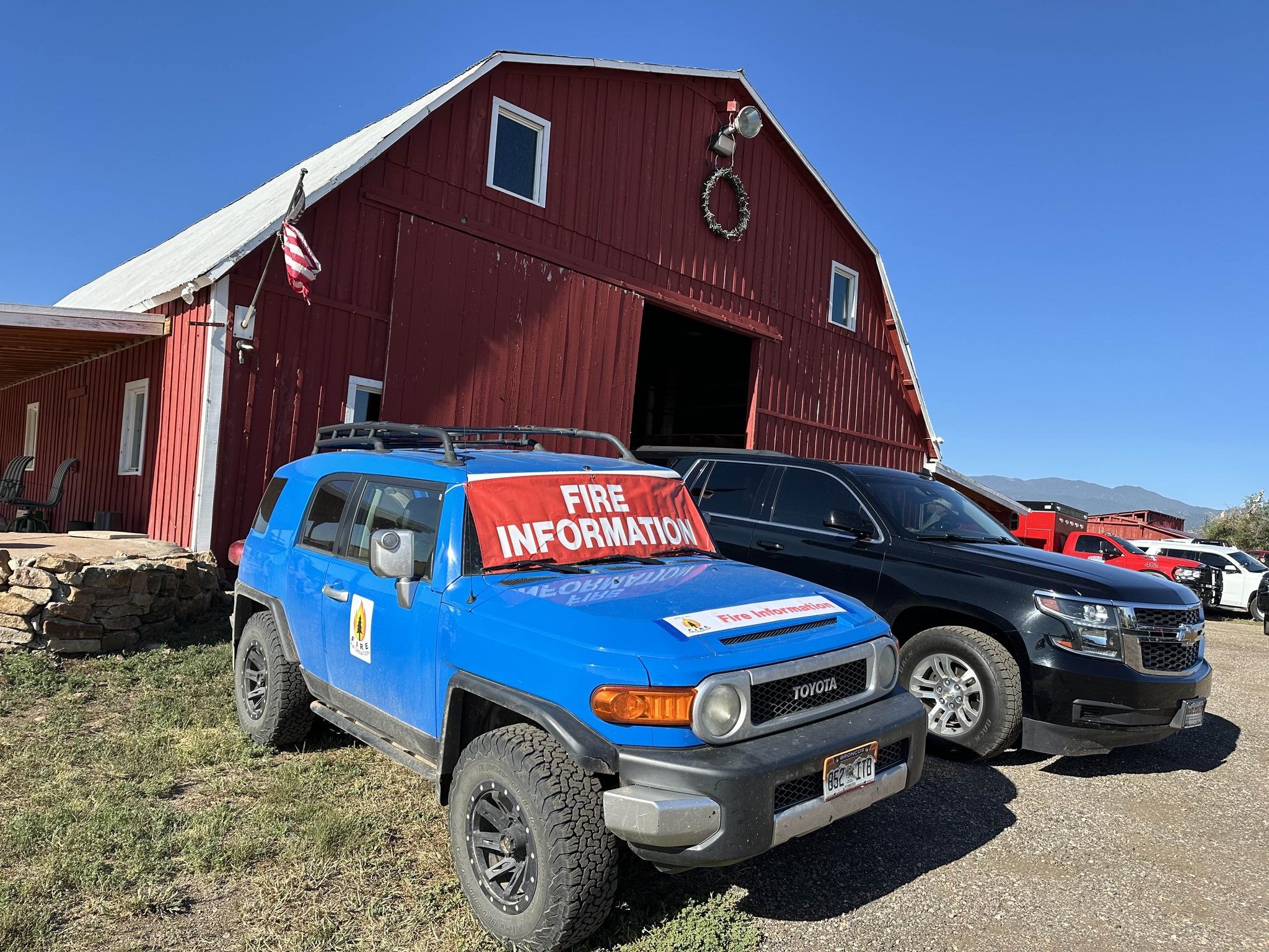 To show public information officers out in the community.... one of the PIO vehicles is parked outside of the Goospasture Barn during their July 4th pancake breakfast. On the windshield is a red "public information" banner to show the public that they can find information about the Oak Ridge Fire at that vehicle.