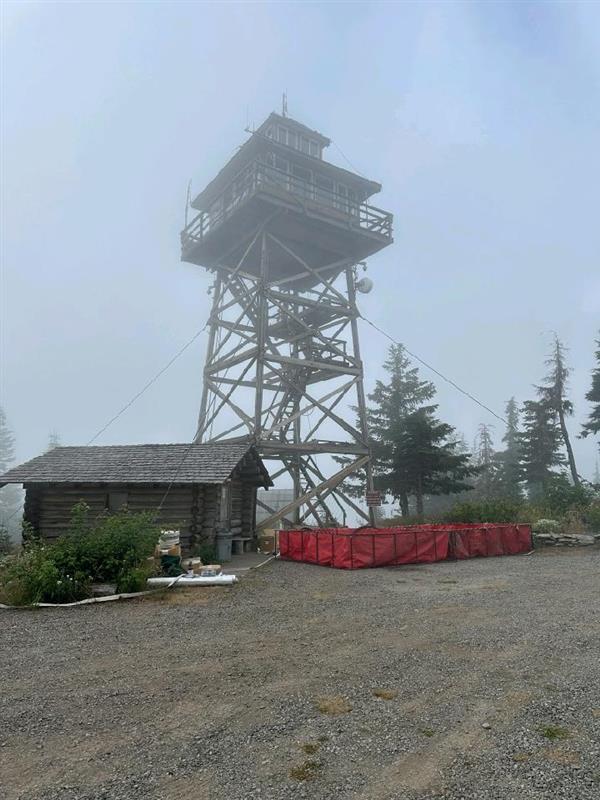 Smoke and fog mix at Warner Lookout. A water tank sits at the base. July 30