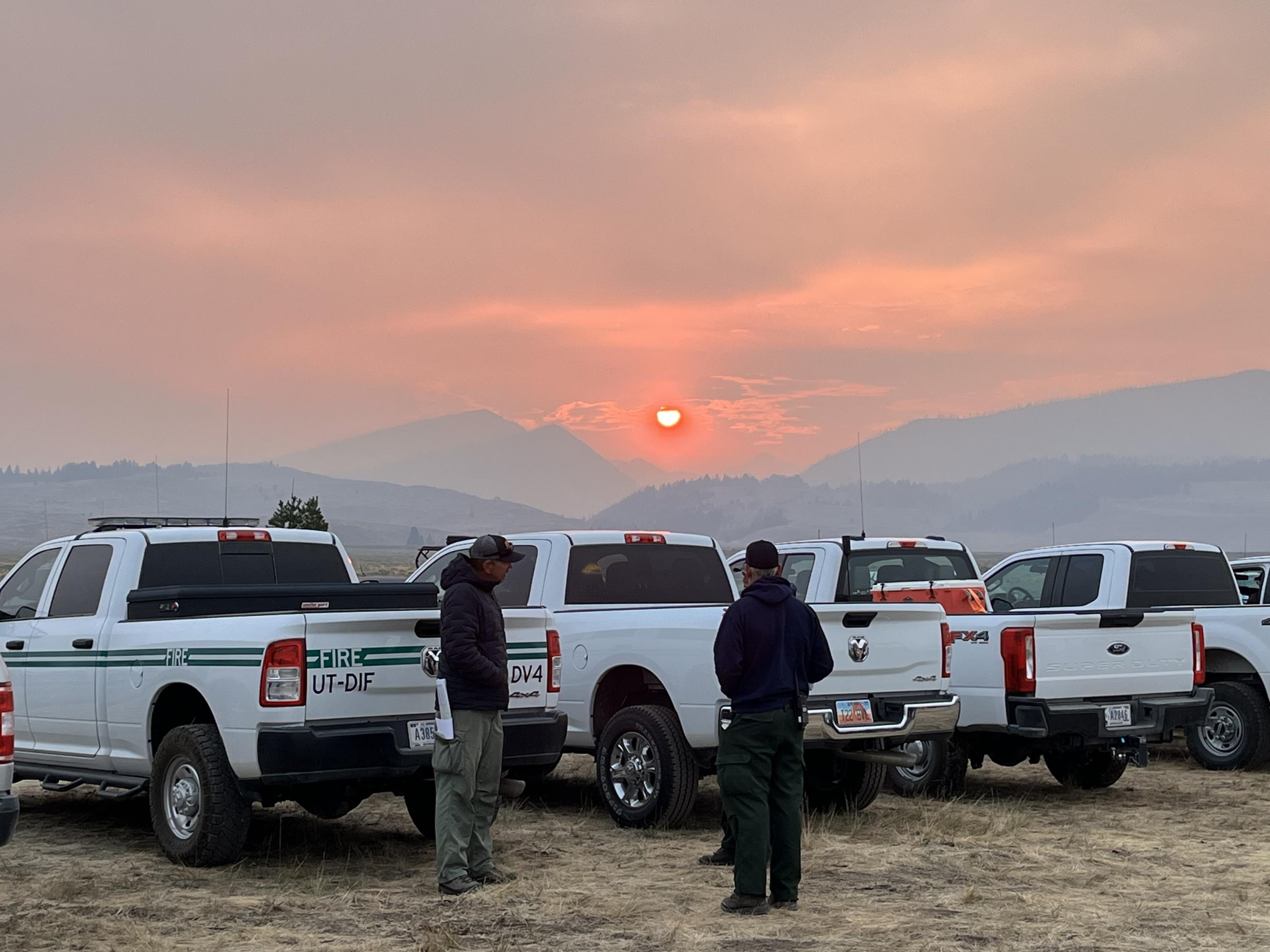 Fire personnel discuss plans before morning briefing, July 27, 2024