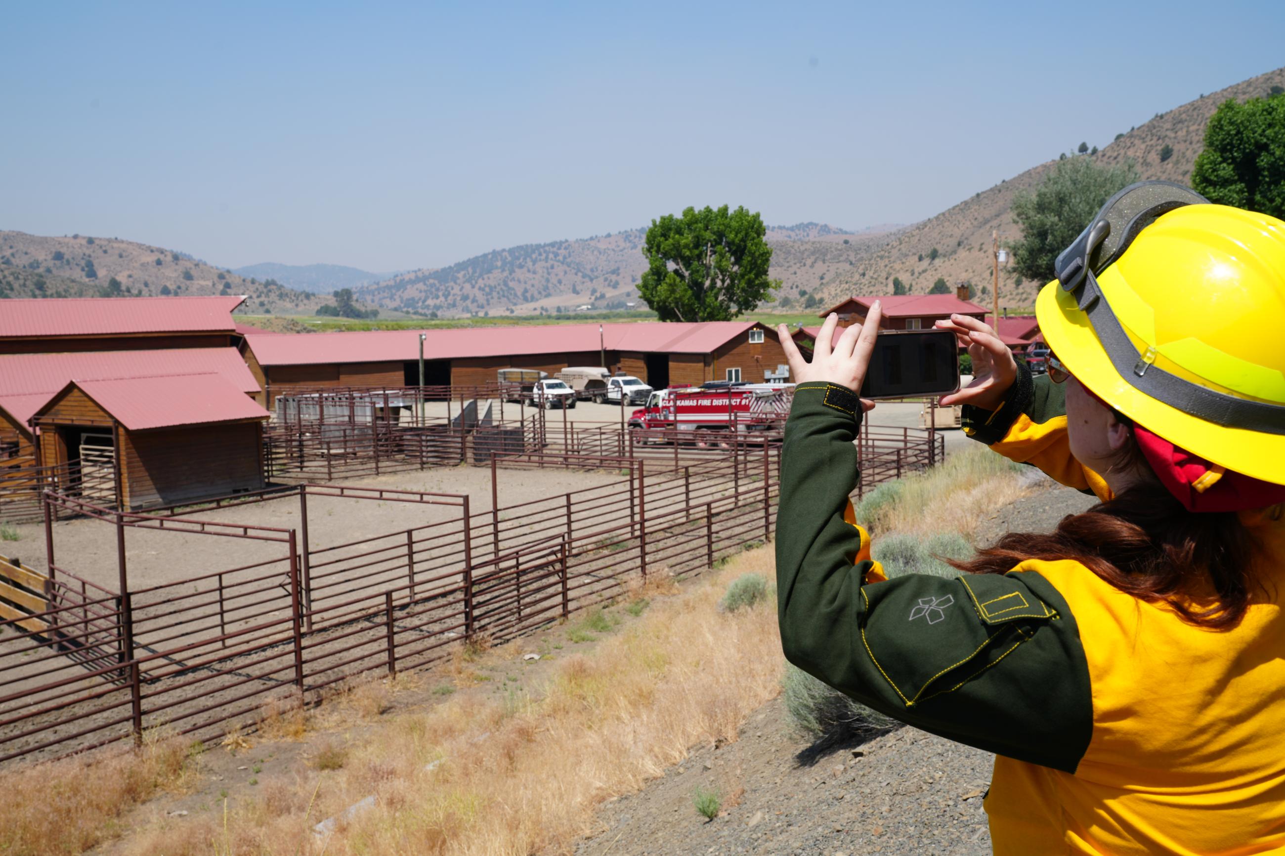 Firefighter taking a picture of a ranch