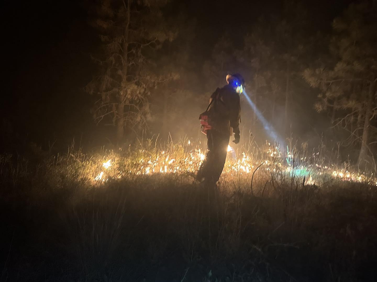 Firefighter burning at night on the Lone Rock Fire