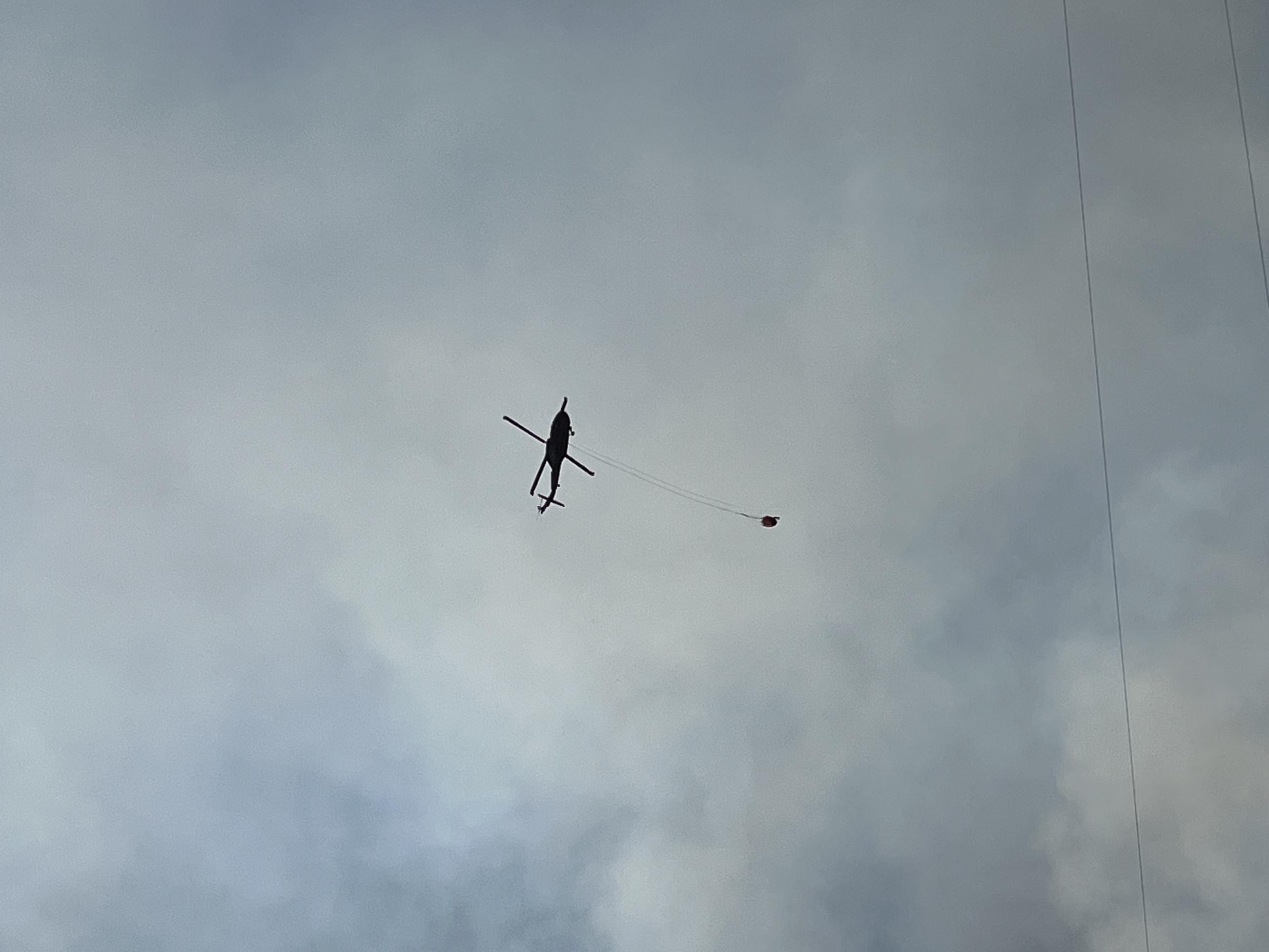 Helicopter Hauling Water To The Fire