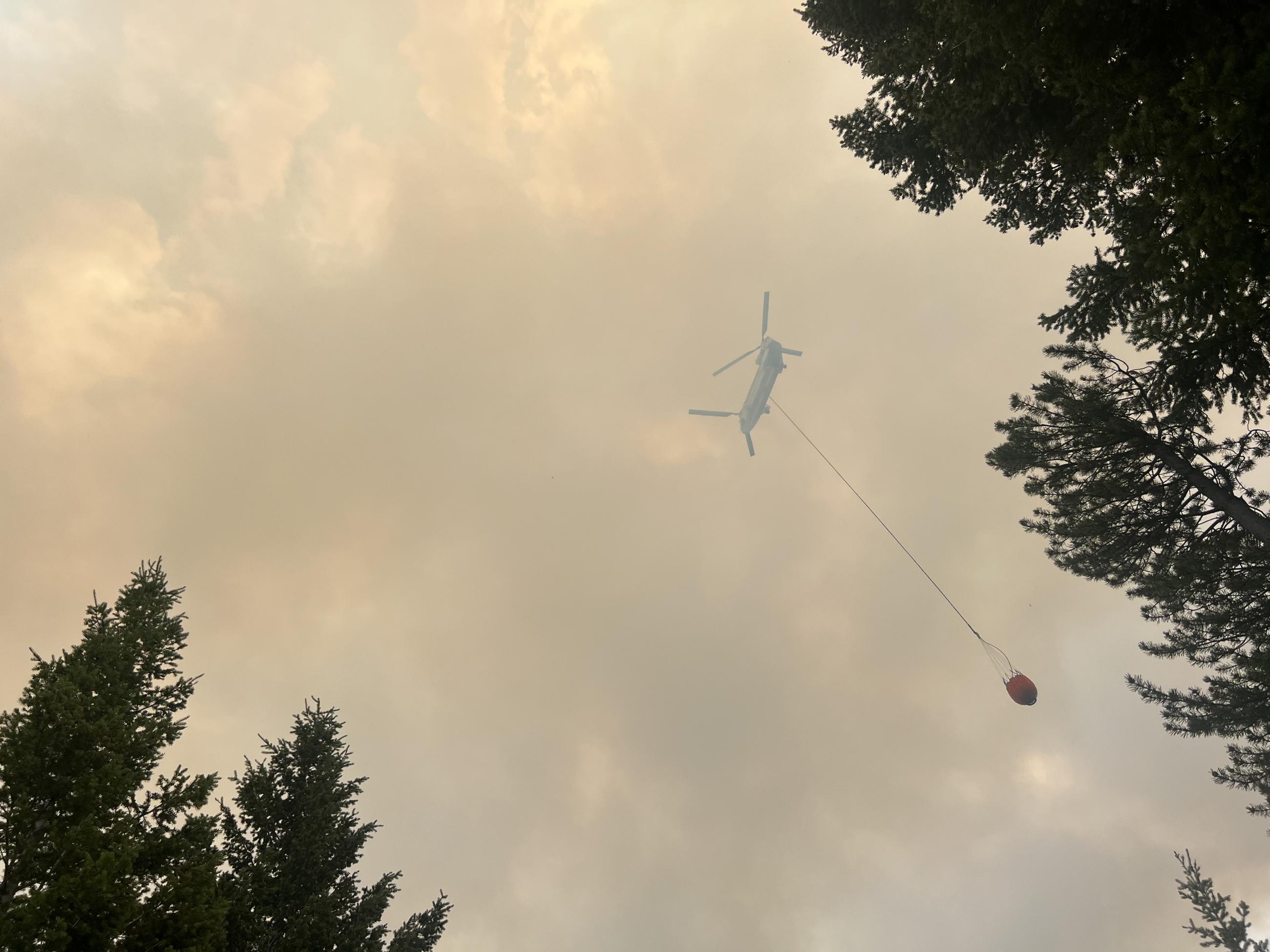 helicopter flying in smokey skies 