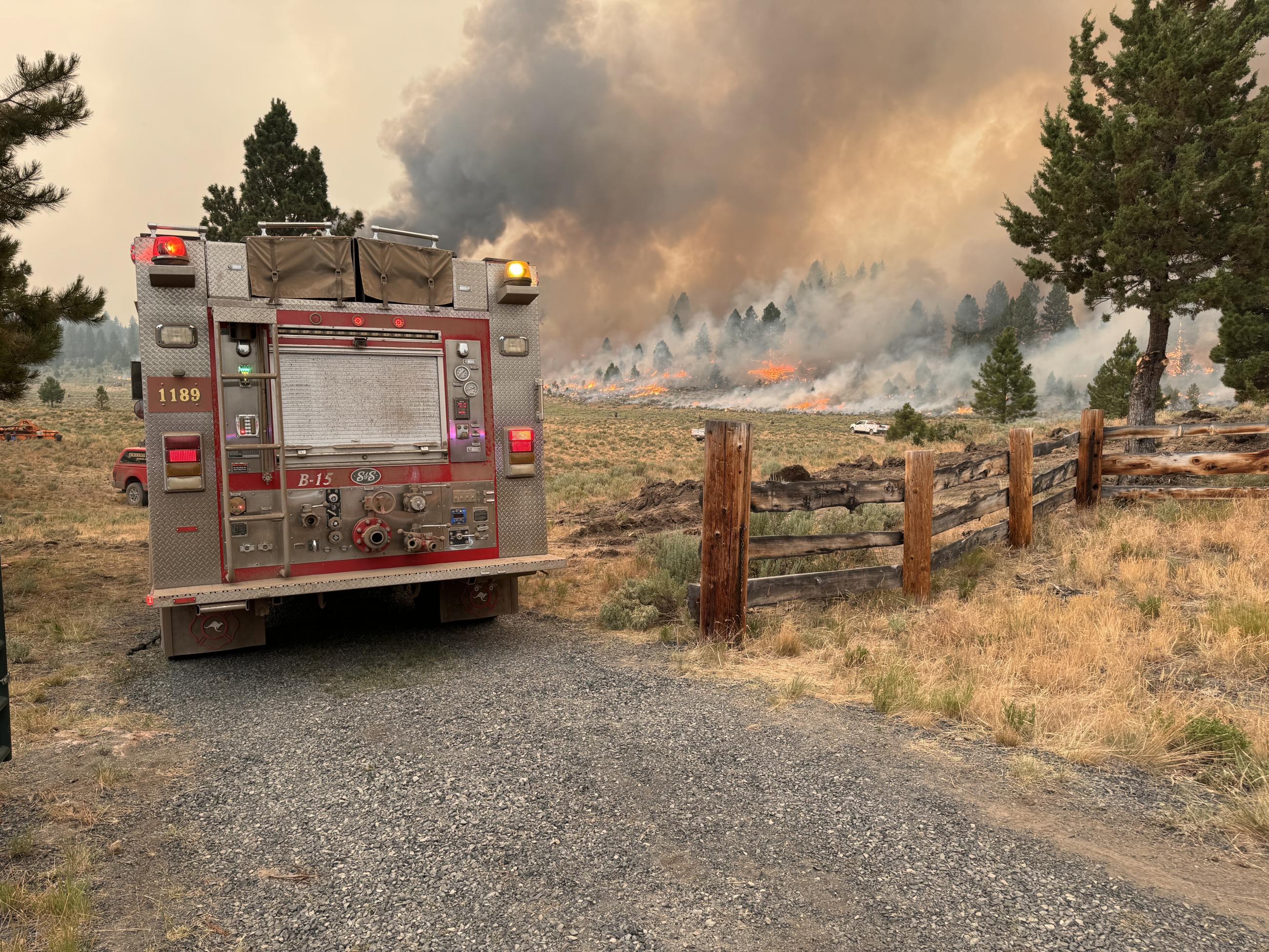 Structure firefighters protect a yurt on the Falls Fire. 2024.