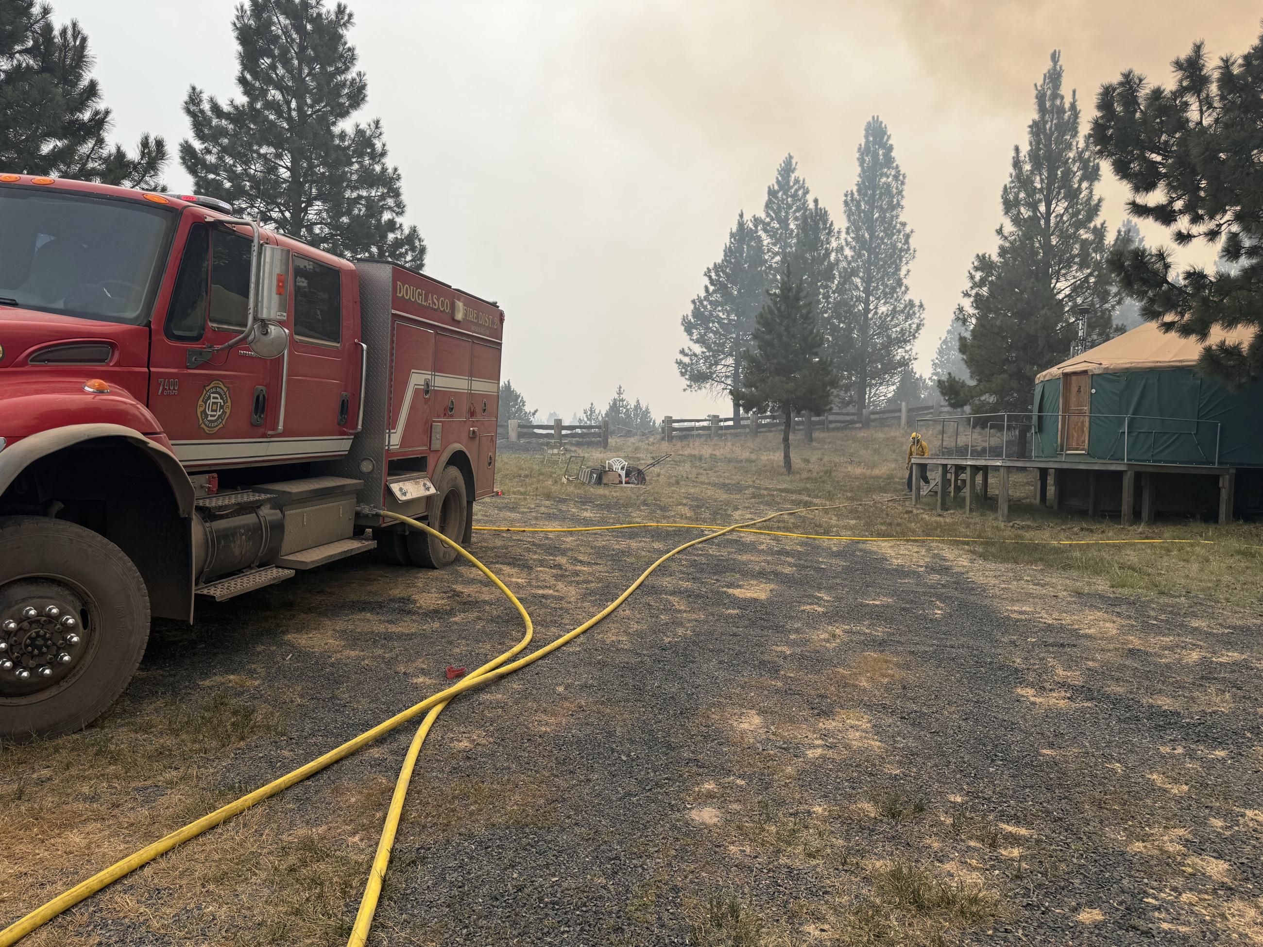 Structure firefighters protect a yurt on the Falls Fire. 2024.