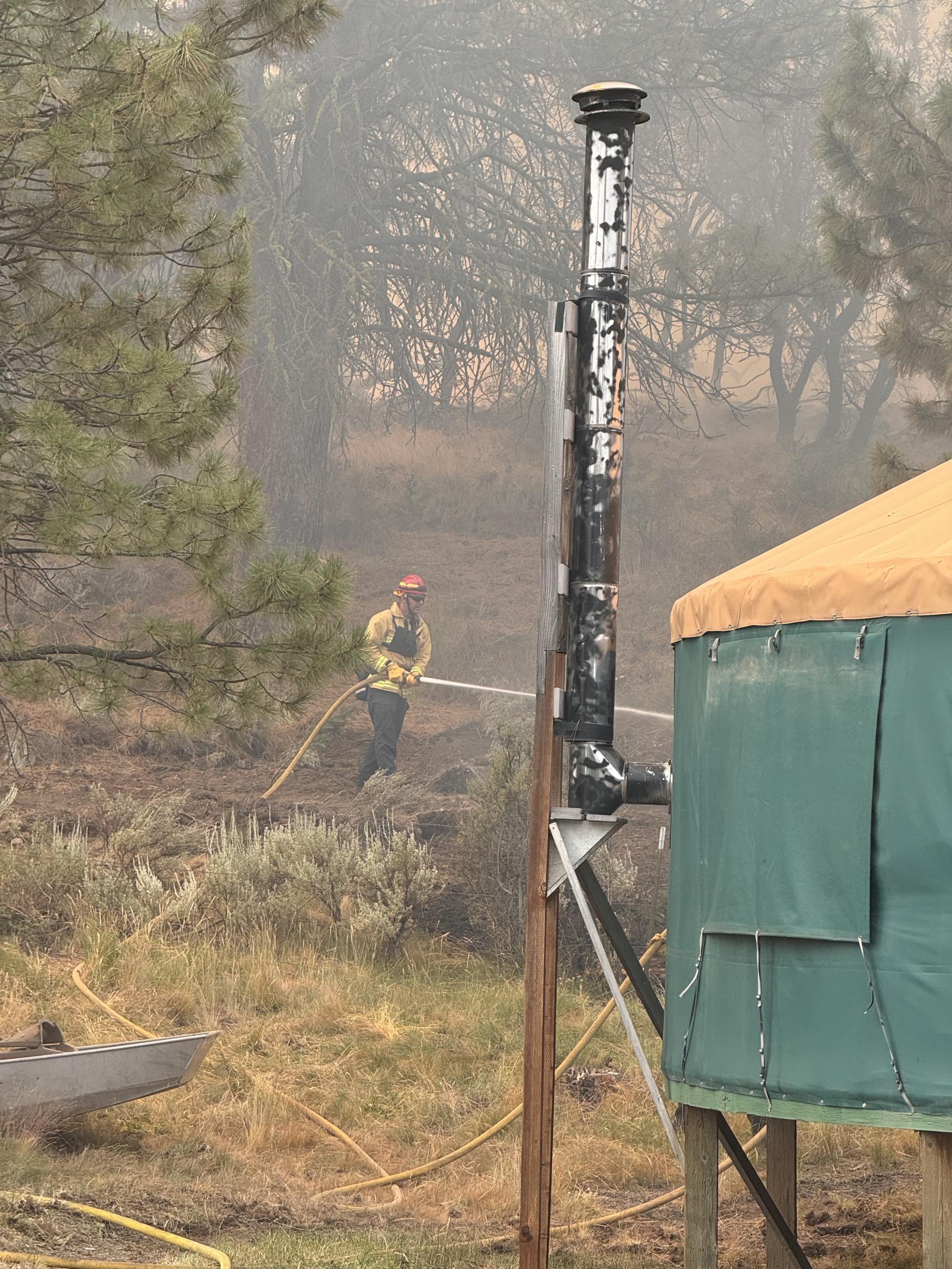 Structure firefighters protect a yurt on the Falls Fire. 2024.