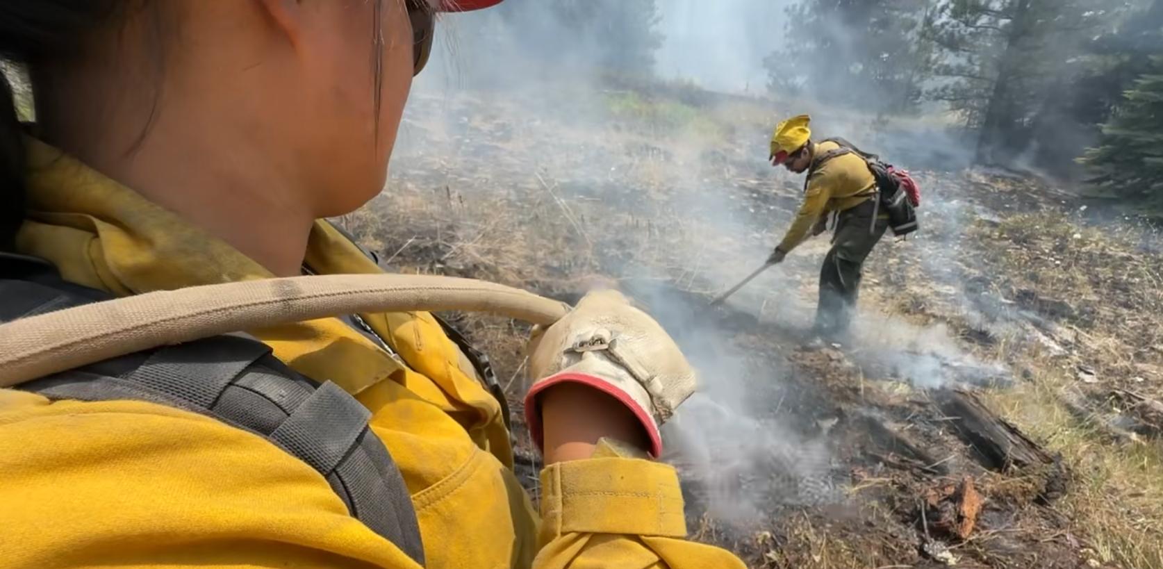 Firefighters mop up to secure the fire's edge