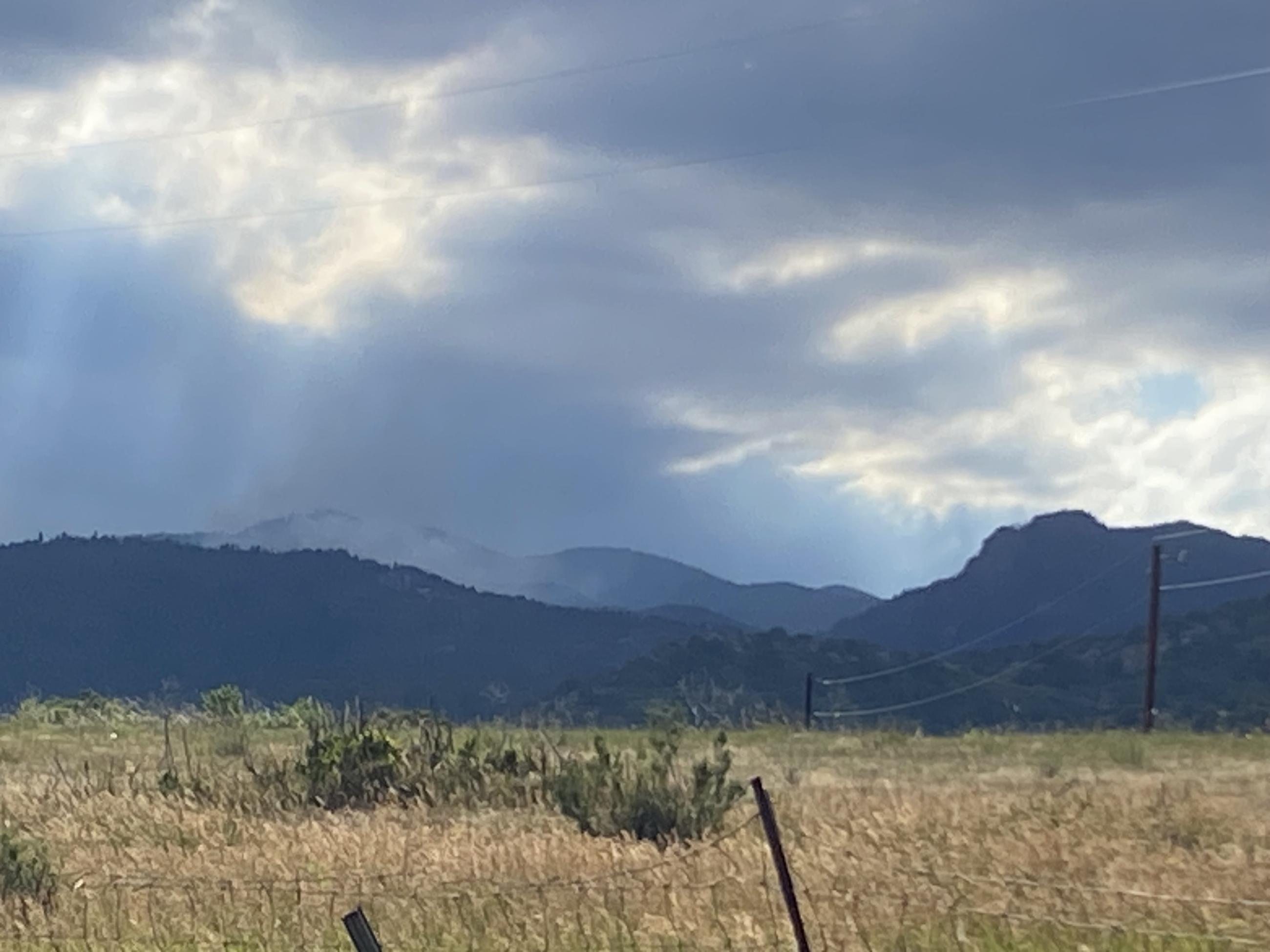 Image of Oak Ridge Fire evening strategic firing operations occurring in Division Kilo with light smoke and heavy cloud covering coming into the area.