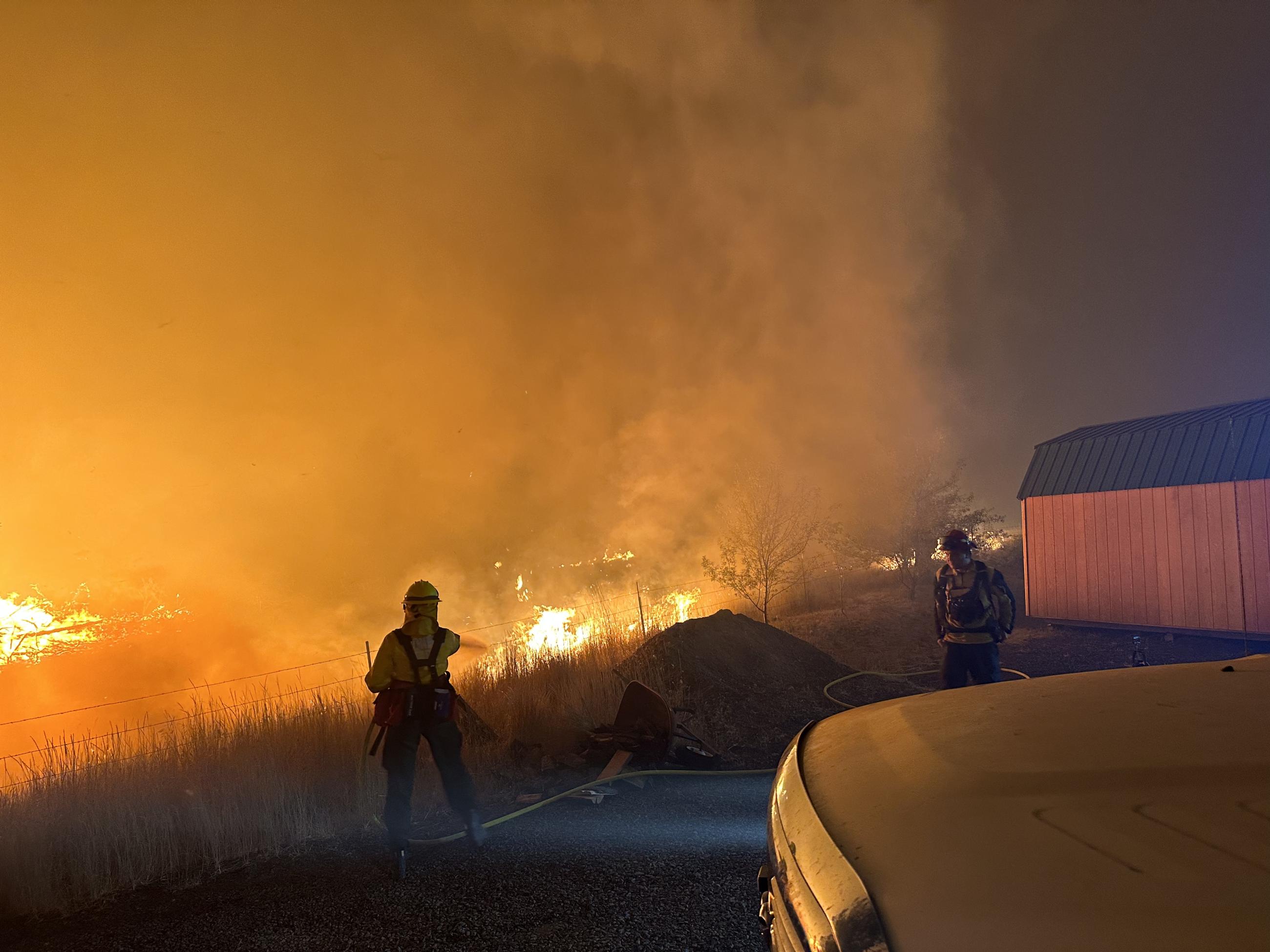 Firefighters protecting structures during night shift on the Lone Rock Fire