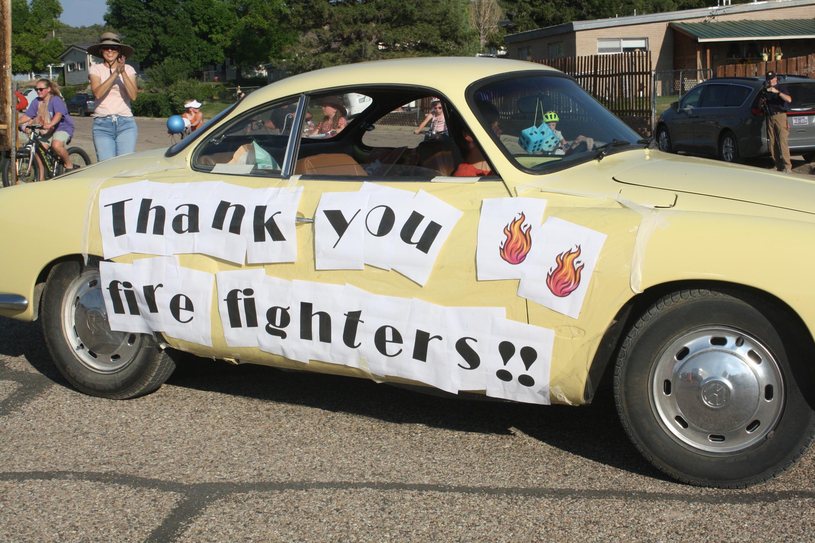 Pioneer Day parade with Thank You, Firefighters sign