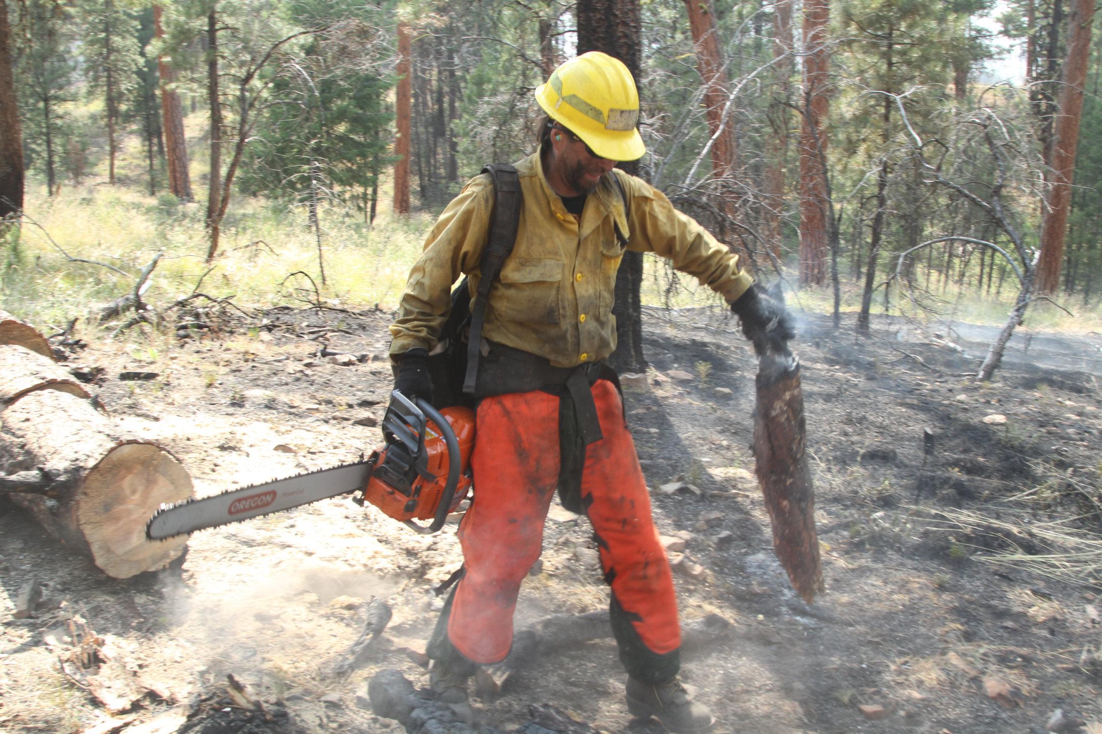 Sawyer moves burning debris