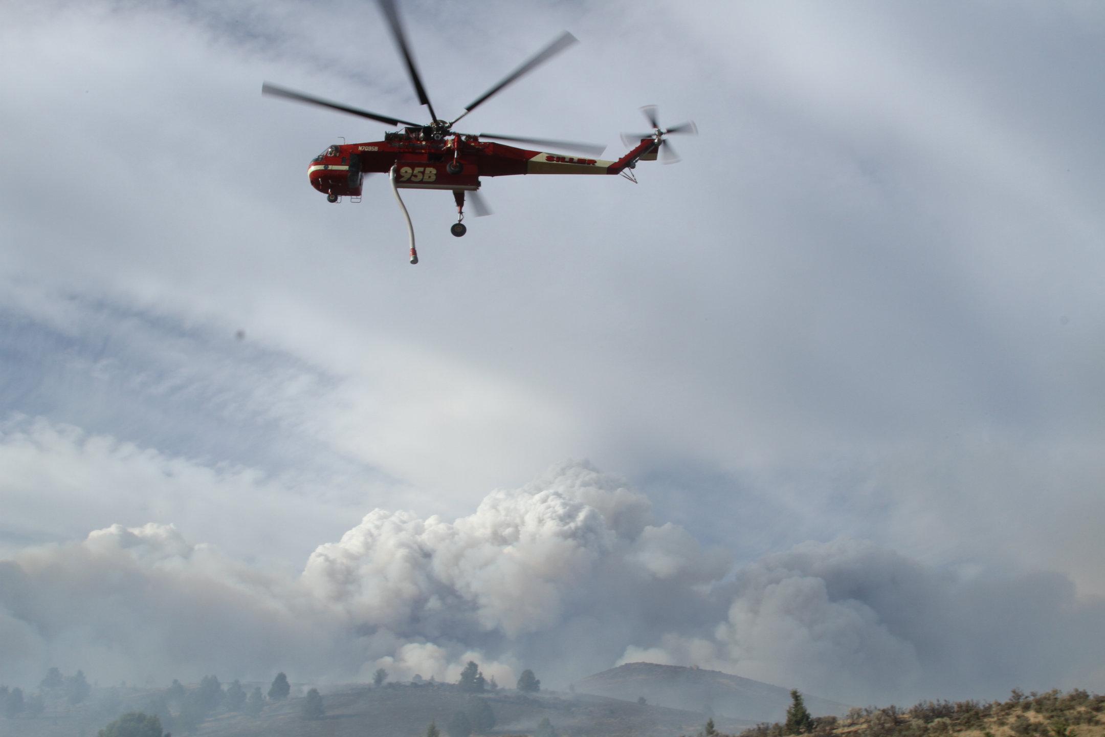 Sky Crane Helicopter above large Smoke Column