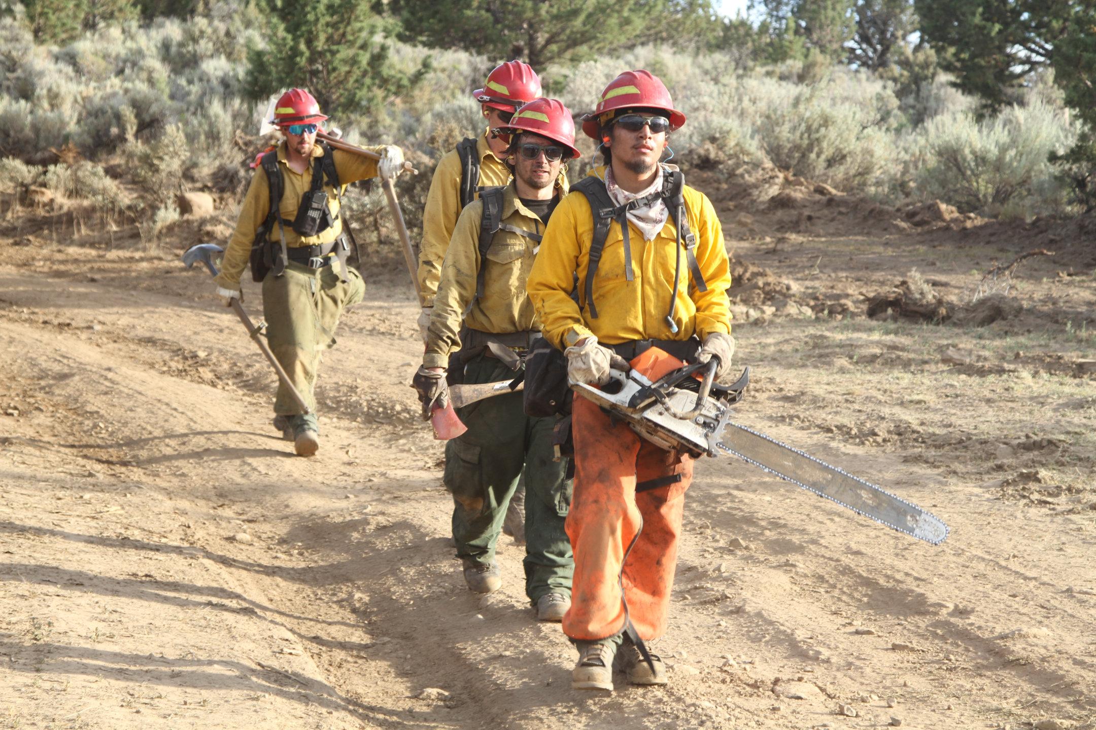 Squad of Firefighters Hikes Along Road in Div O. July 17.