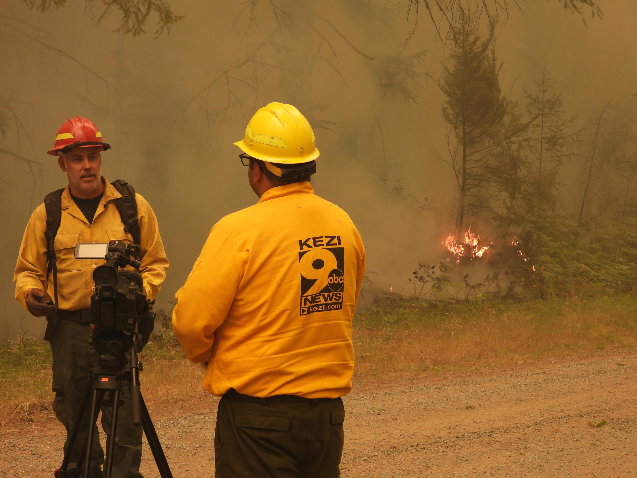  a firefighter si interviewed by the media along the fireline on Chalk fire, July 28