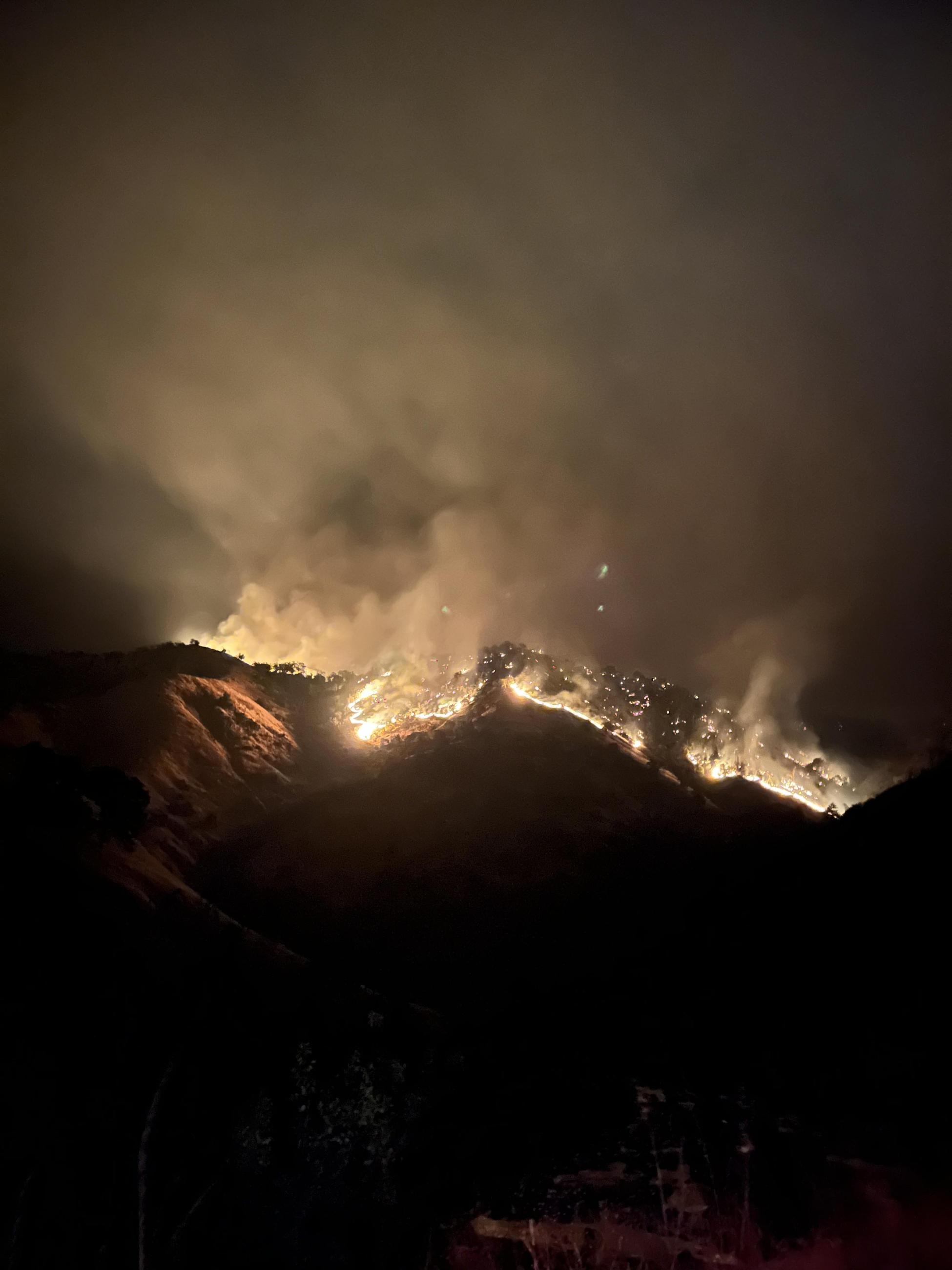 the Basin Fire burns as dusk.