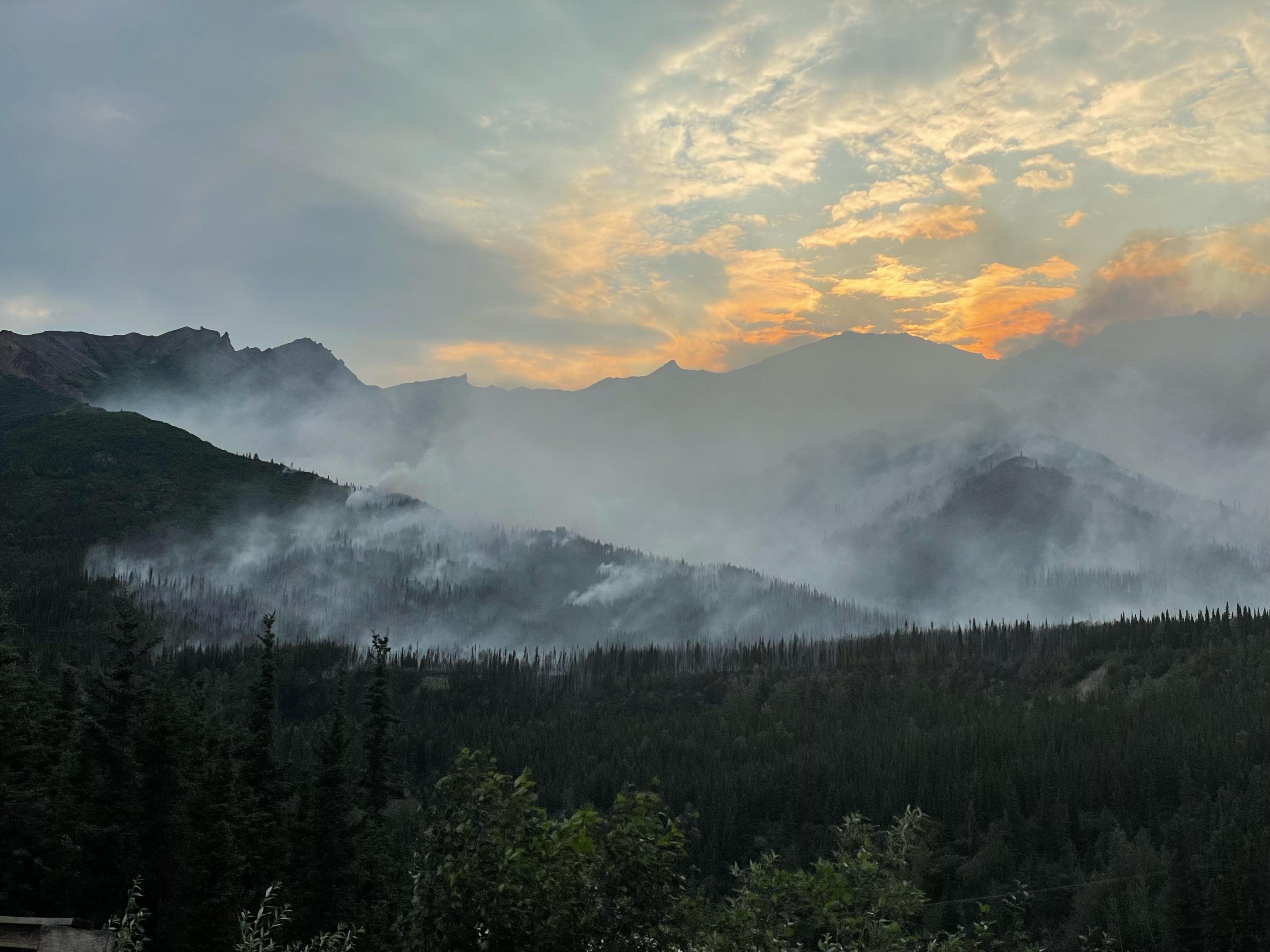 Smoke in the mountains with a nectarine sunset