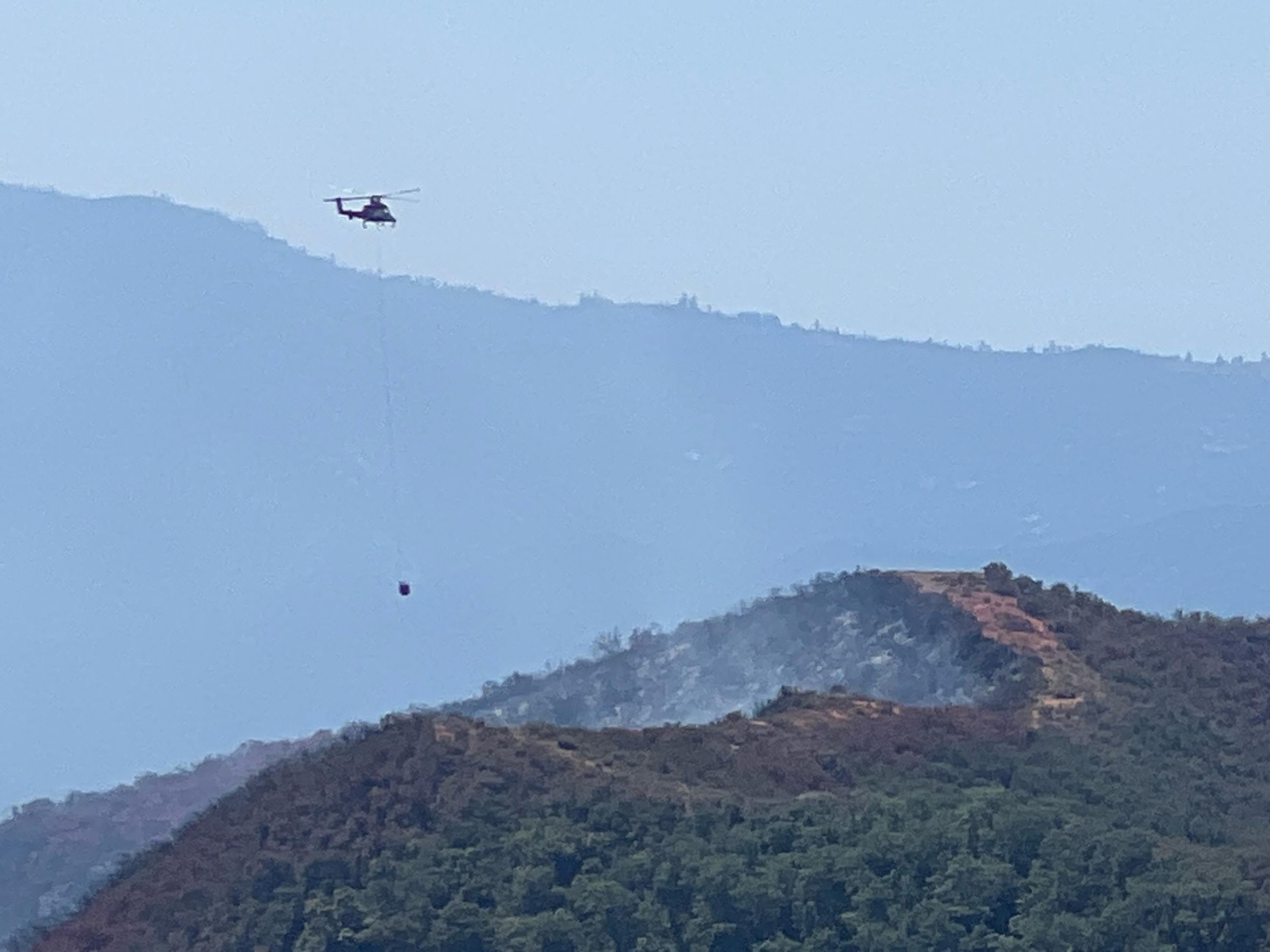 Helicopter flies over the Basin Fire