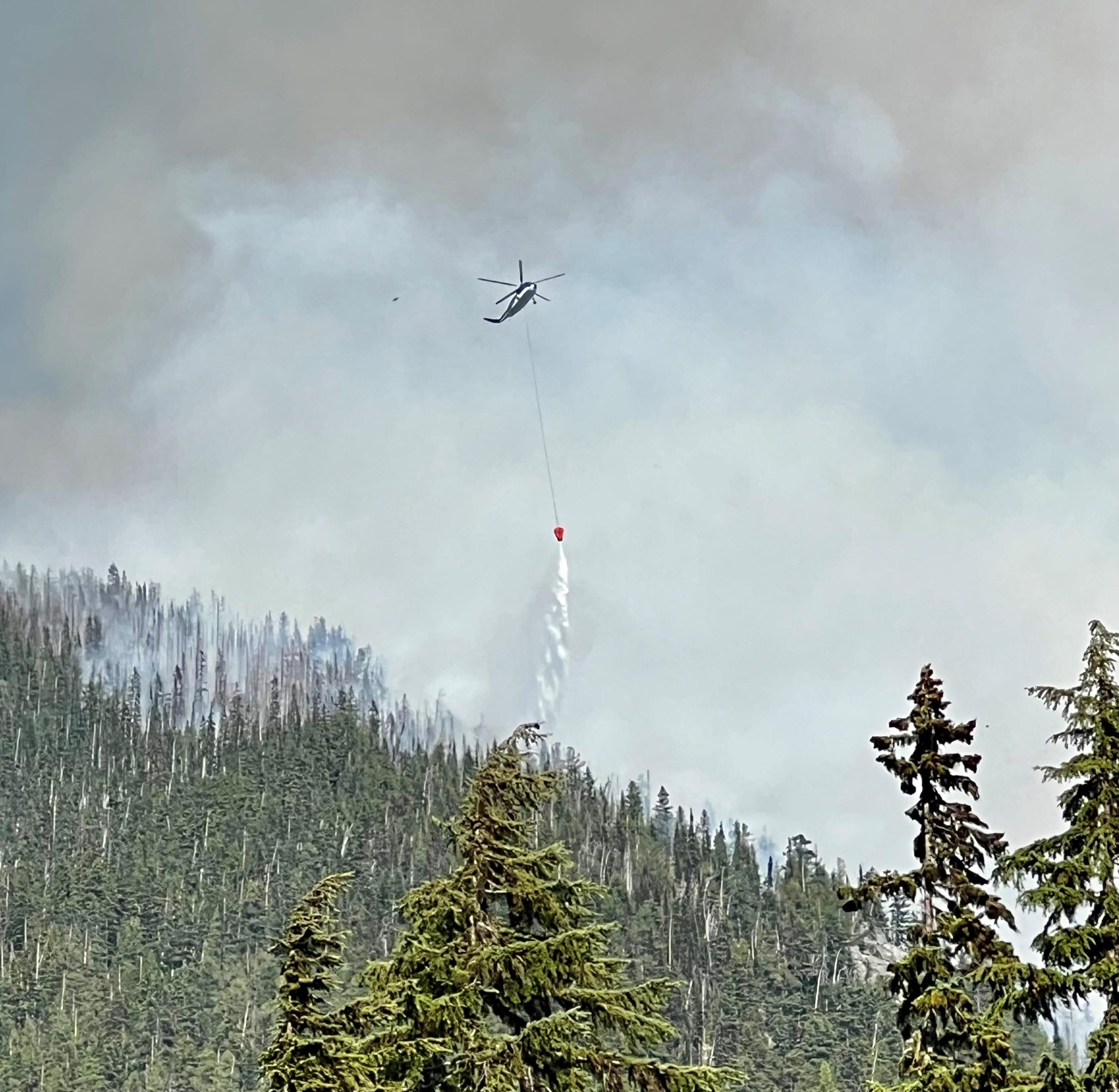 Helicopter with bucket water drop.