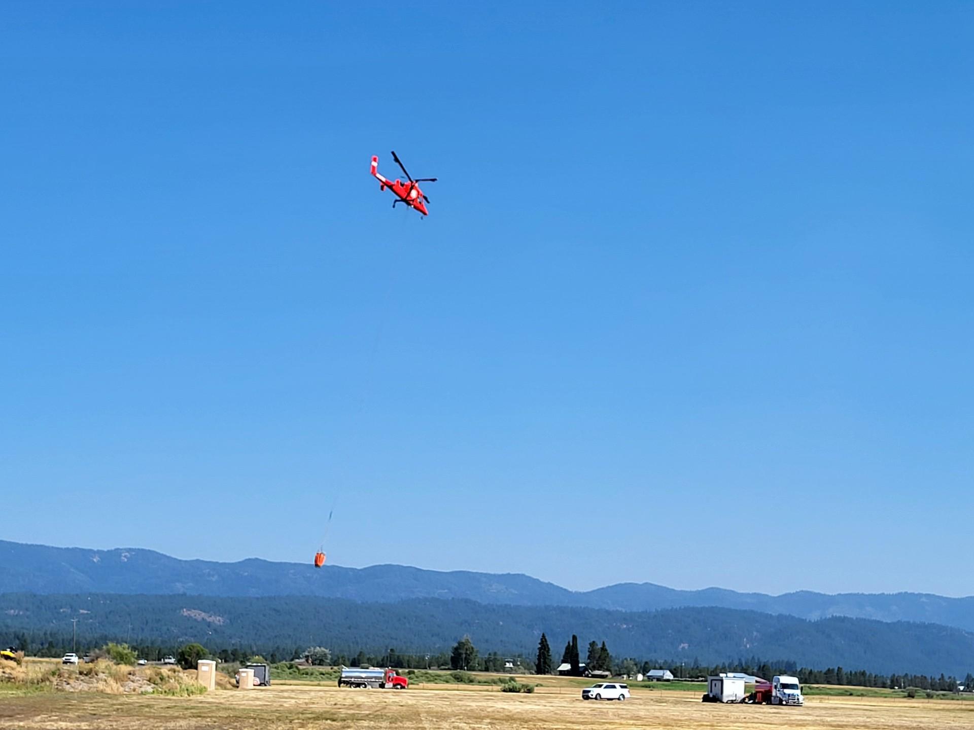 KMax Helicopter and bucket take off from helibase