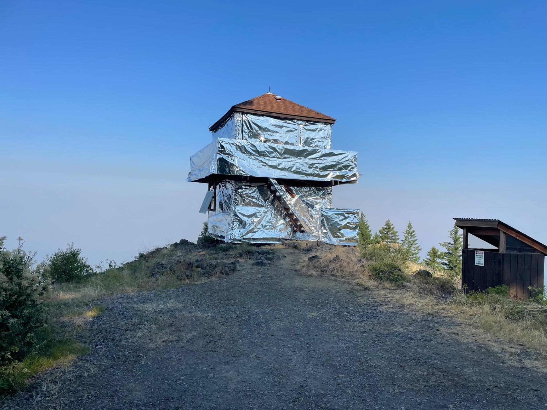 The Pig Iron Lookout is wrapped in shiny silver protective sheeting