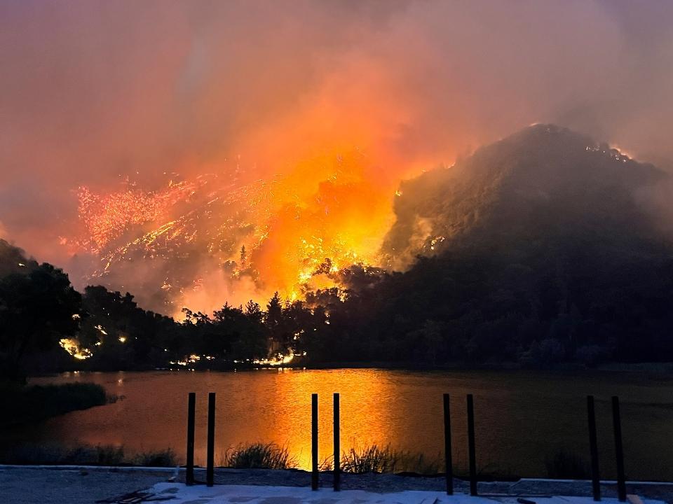 Flames reflect onto the lake near sundowns, July 6, 2024