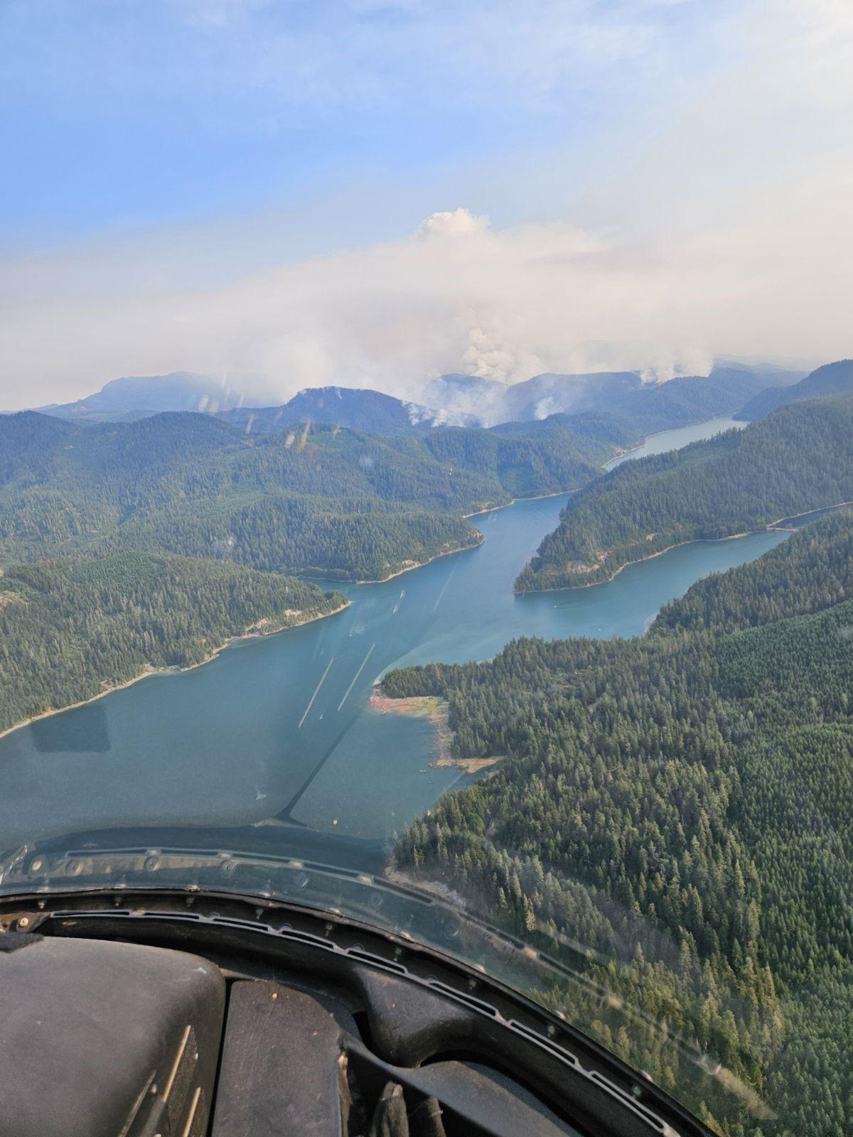 smoke rises from coffeepot fire as seen from occupants of helicopter July 27