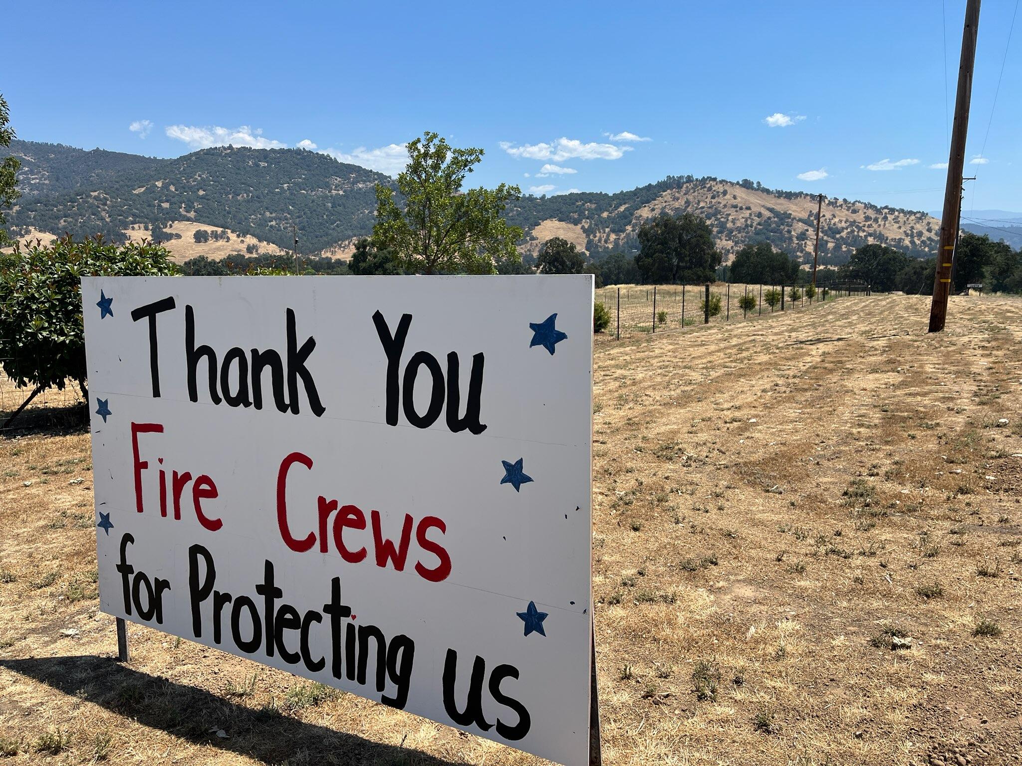 A thank you firefighters sign is posted along the road.